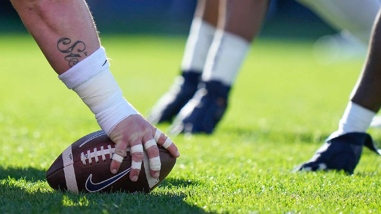 Players line up at the line of scrimmage during the first half of an NCAA college football game in East Hartford, Conn., Saturday, Nov. 12, 2022.
