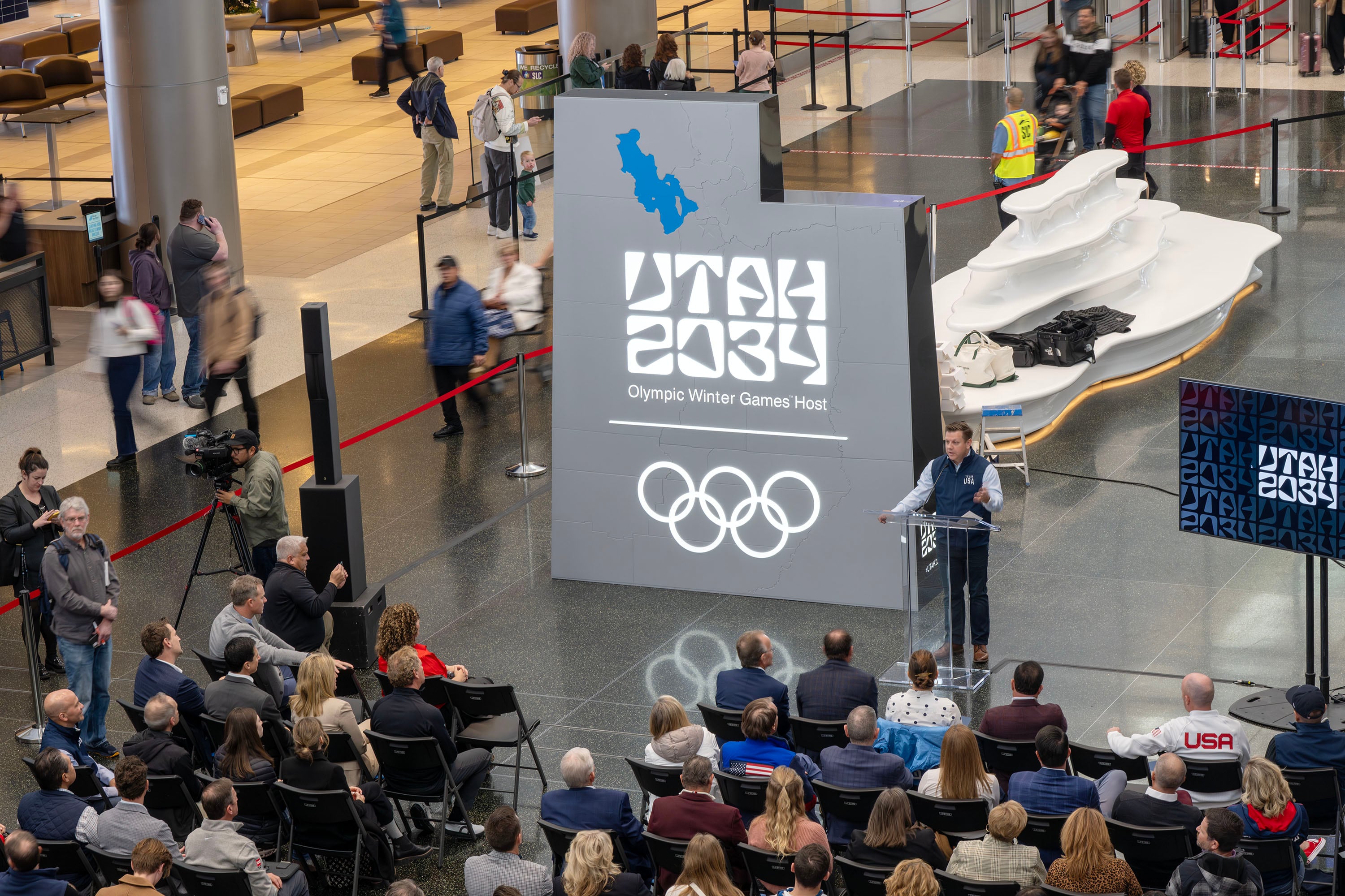 Steve Starks, vice chairman of the Organizing Committee for the 2034 Olympic and Paralympic Winter Games, speaks prior to showing a video as he and other members of the organizing committee and state and local leaders, including a few former athletes, gather to celebrate 3,000 days until the 2034 Winter Olympics during a ceremony at the Salt Lake City International Airport on Nov. 24.