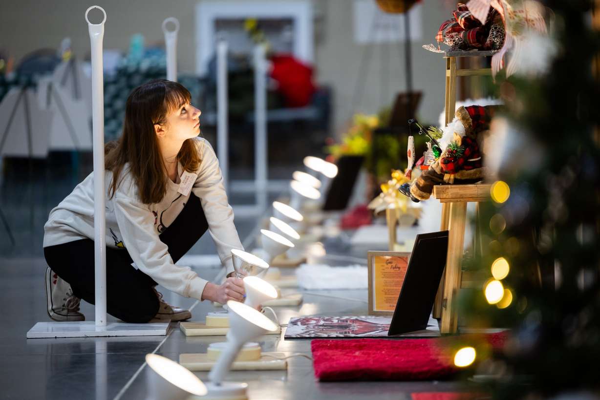 Kelsey Cromar, a member of the Festival of Lights executive board, sets up for this year’s Festival of Trees at the Mountain America Expo Center in Sandy on Tuesday. Funds raised at the Festival of Trees support the Intermountain Health Primary Children's Hospital.