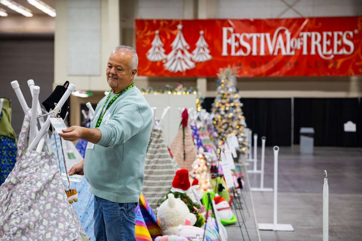 Dan Craner, member of the Festival of Trees executive board, puts tags on all the trees before this year’s Festival of Trees at the Mountain America Expo Center in Sandy on Tuesday. Funds raised at the Festival of Trees support the Intermountain Health Primary Children's Hospital.