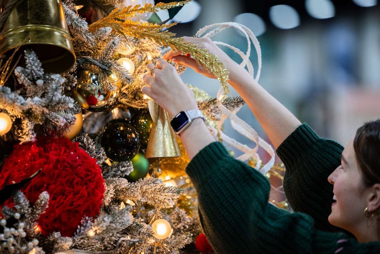 Livie Smart, 17, patient champion for this year’s Festival of Trees, hangs a bell on a tree made in her honor at the Mountain America Expo Center in Sandy on Tuesday. Funds raised at the Festival of Trees support the Primary Children’s Hospital.