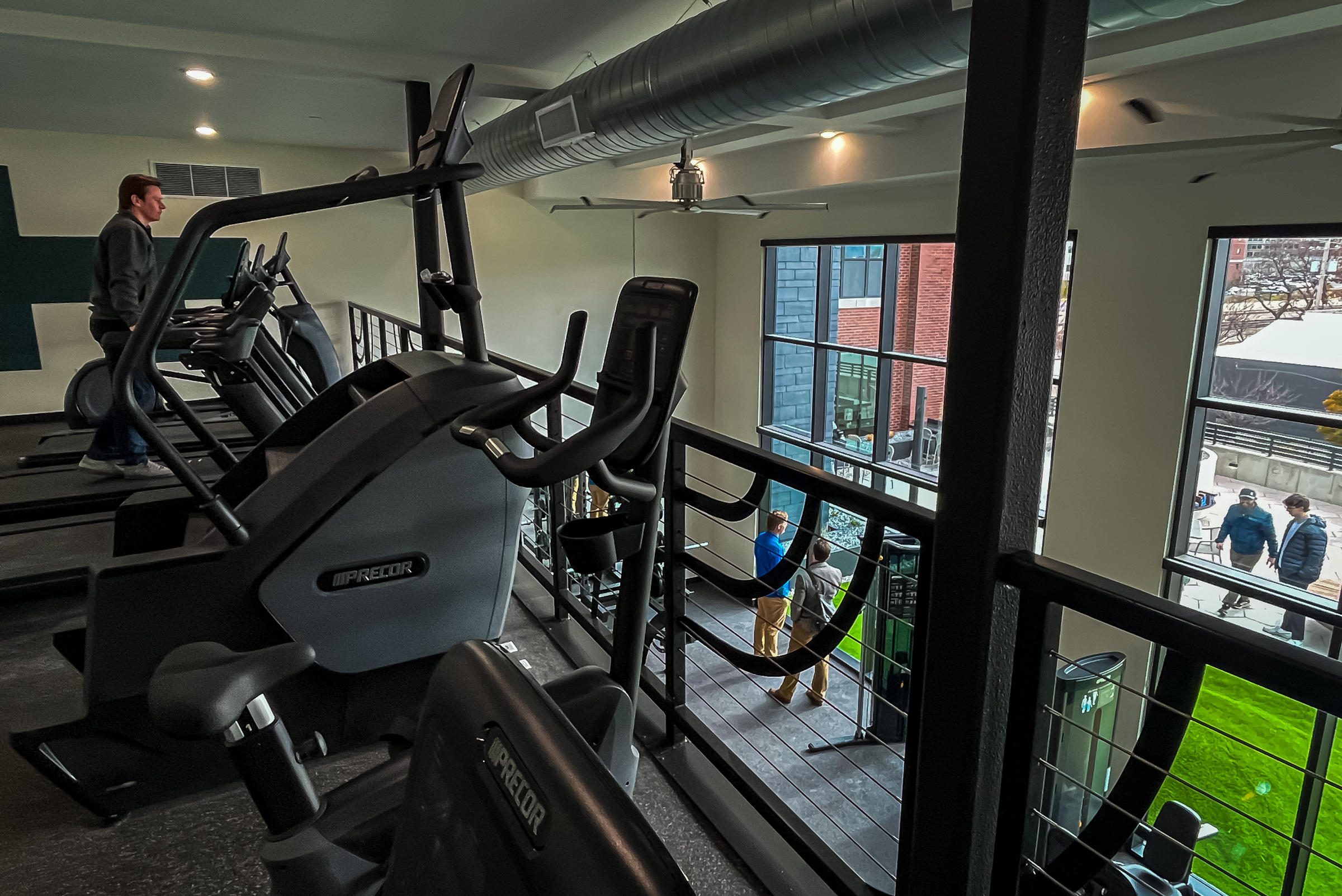 People explore the two-story fitness center within the addition of Citizens West in Salt Lake City that opened on Tuesday.
