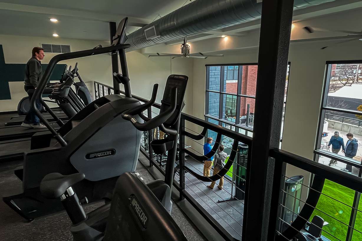 People explore the two-story fitness center within the addition of Citizens West in Salt Lake City that opened on Tuesday.