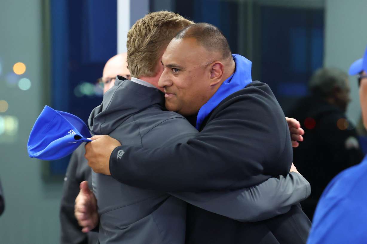 BYU head football coach Kalani Sitake hugs BYU safety Tanner Wall after a press conference held at the Student Athlete Building in Provo on Tuesday, Dec. 2, 2025.