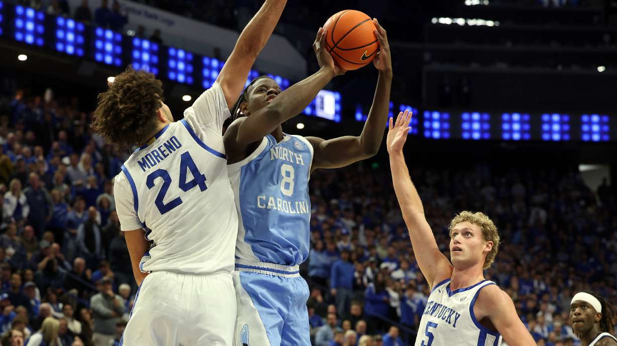 North Carolina's Caleb Wilson (8) shoots between Kentucky's Malachi Moreno (24) and Collin Chandler (5) during the second half of an NCAA college basketball game in Lexington, Ky., Tuesday, Dec. 2, 2025.
