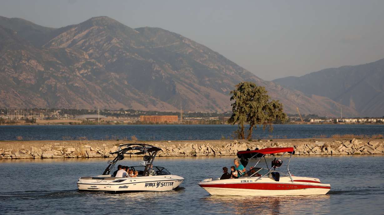 Two boats pass at American Fork Boat Harbor in American Fork on June 30.