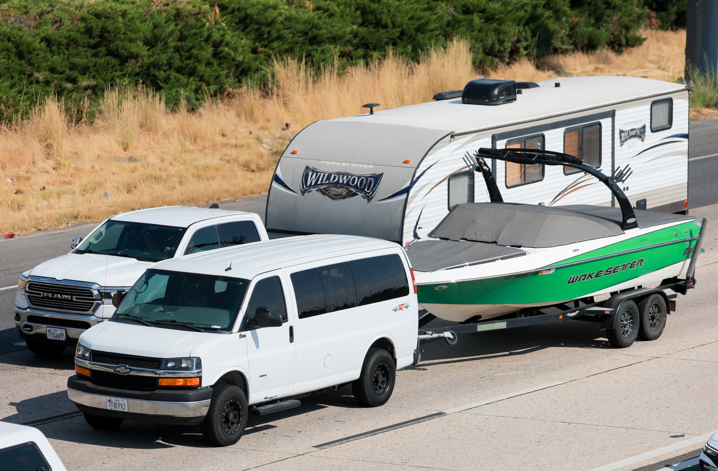 A truck pulling a camper and a van pulling a boat head north on I-15 near Layton ahead of the holiday weekend on Aug. 29.