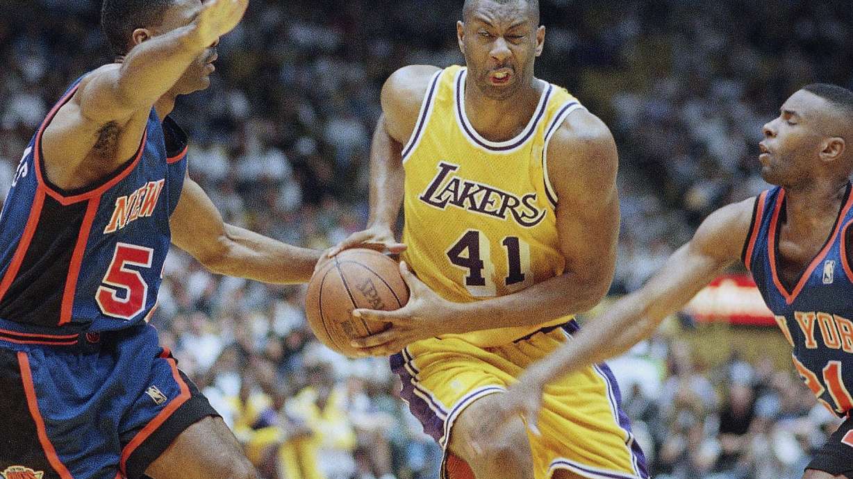 FILE - Elden Campbell (41) of the Los Angeles Lakers drives to the basket as Buck Williams left, and Charlie Ward of the New York Knicks defend, during the second half of their game on Sunday, Feb. 23, 1997 in Inglewood, Calif.