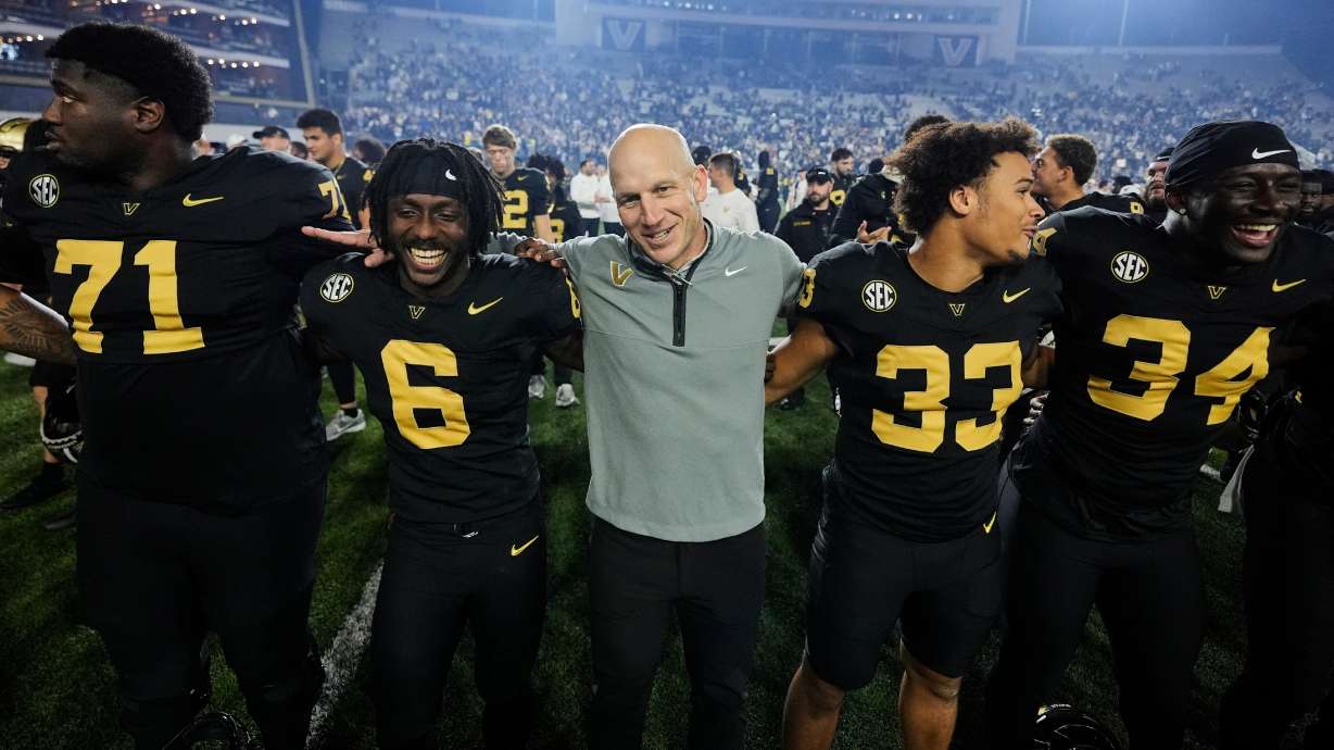 Vanderbilt head coach Clark Lea, center, celebrates the team's win with players after an NCAA college football game against Kentucky, Saturday, Nov. 22, 2025, in Nashville, Tenn.