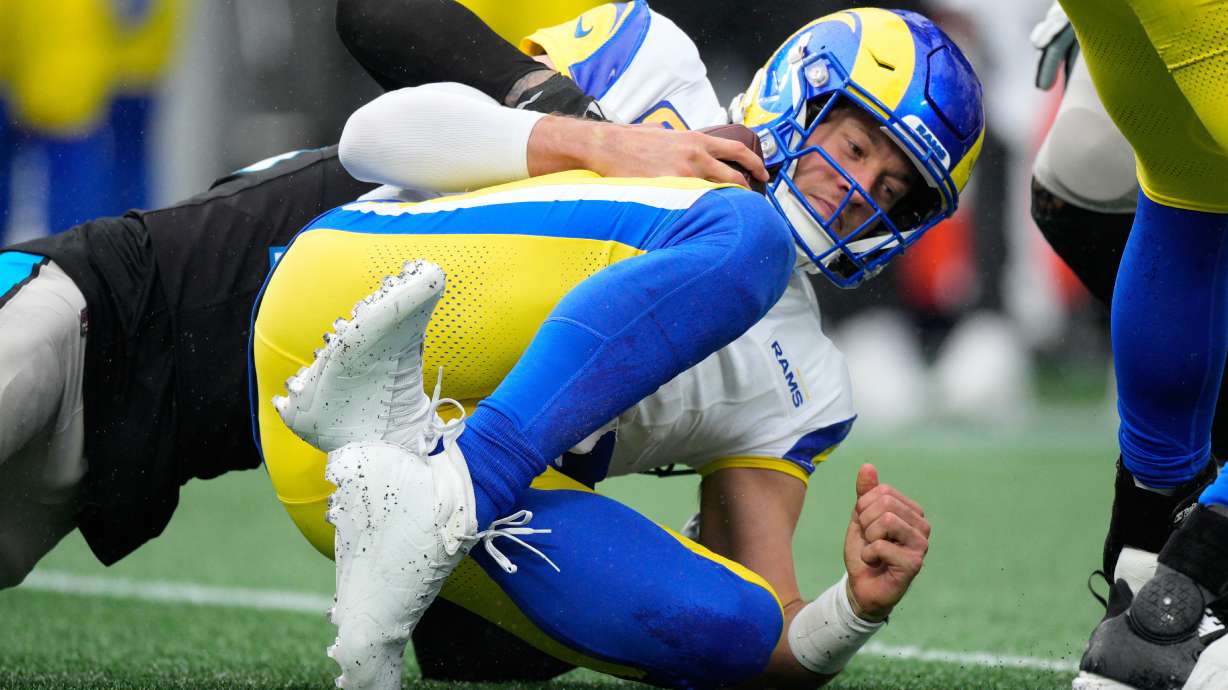 Los Angeles Rams quarterback Matthew Stafford is sacked by Carolina Panthers safety Lathan Ransom during the second half of an NFL football game, Sunday, Nov. 30, 2025, in Charlotte, N.C.