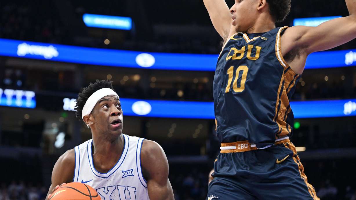 BYU forward AJ Dybantsa (3) fakes California Baptist guard Monty Bowser (10) and spins the opposite way for a basket as BYU and CBU play at the Delta Center in Salt Lake City on Wednesday, Dec. 3, 2025.