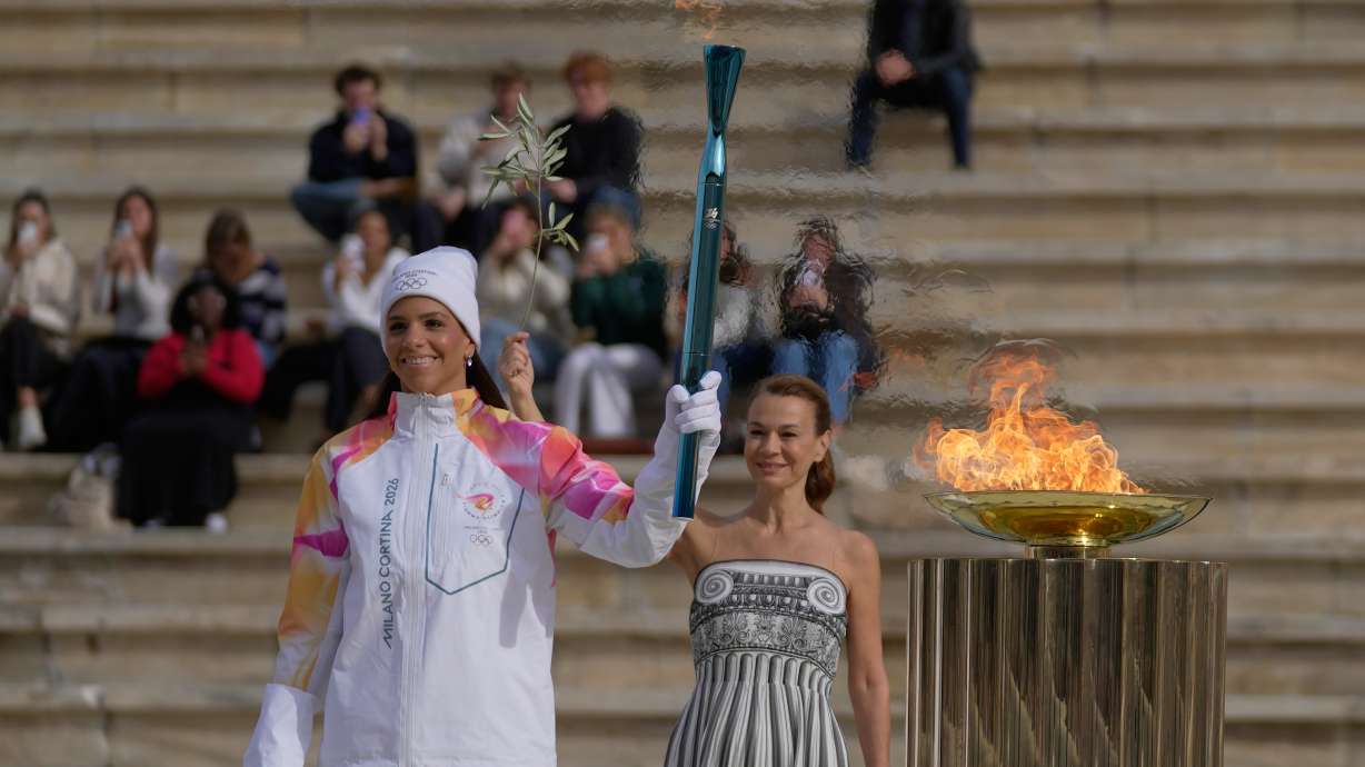 Greek Women's National Water polo player Elena Xenaki lights the cauldron during the Olympic flame handover ceremony for the Milan Cortina 2026 Winter Olympics at Panathenaic stadium, in Athens, Greece, Thursday, Dec. 4, 2025.