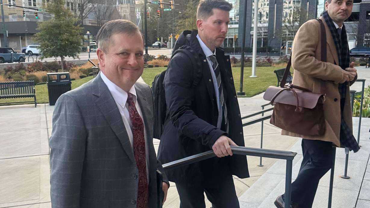 FILE - Front Row Motorsports owner Bob Jenkins, left, and 23XI co-owner Denny Hamlin arrive in the Western District of North Carolina on Monday Dec 1, 2025 in Charlotte, N.C.