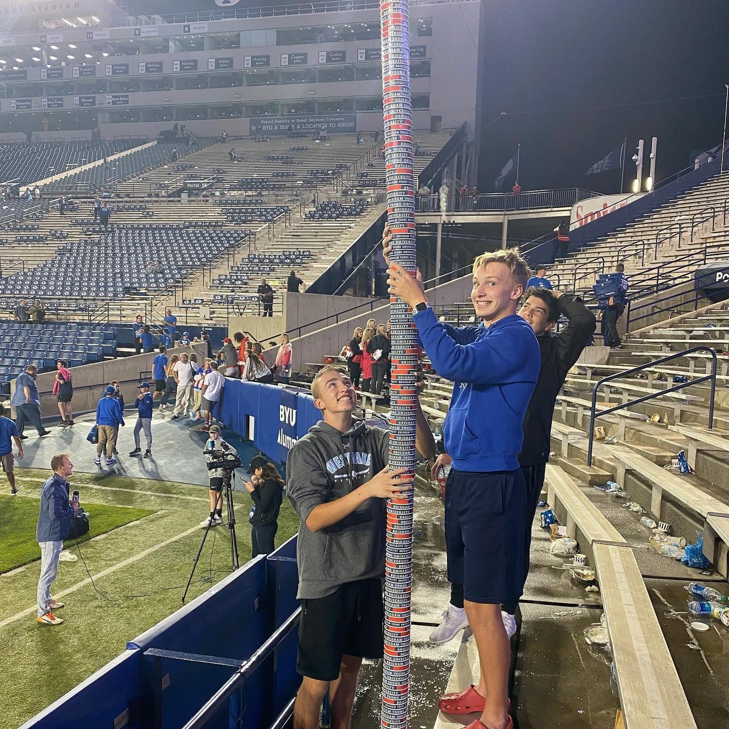 Gavin Cornia and friends collect cups at a BYU football game to make a tower. Cornia died in a head-on collision on Nov. 26. Now, BYU and Texas Tech fans are donating to help his family and his widow, Katie Cornia.