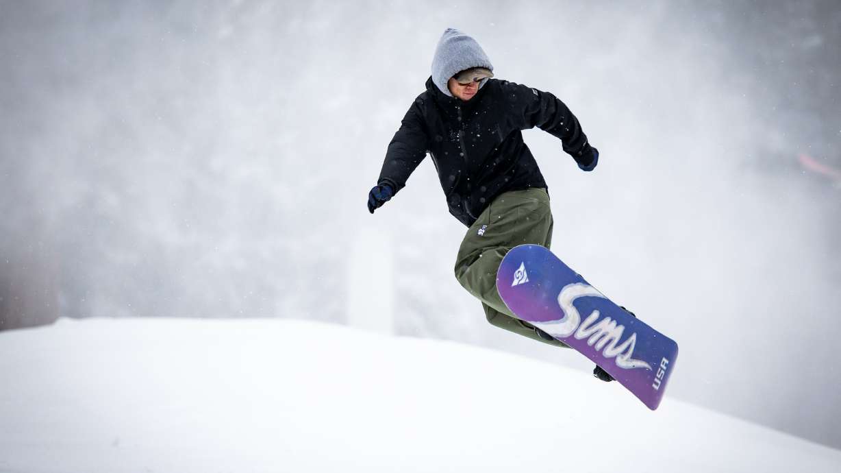 A snowboarder gets some air during opening day at Brighton Resort on Dec. 2. Parts of Utah's mountains could receive close to a foot of snow from an unorganized pattern passing through this weekend, while valleys are expected to receive more rain.