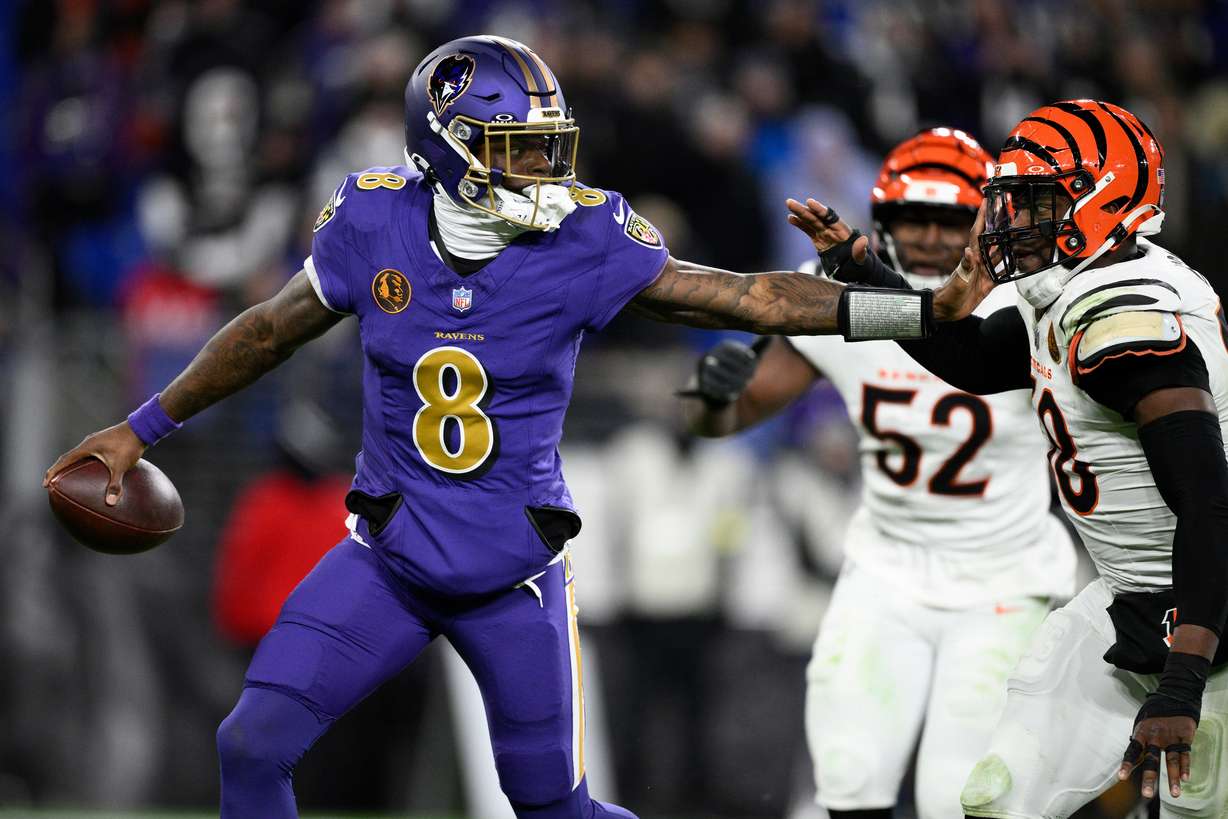 Baltimore Ravens quarterback Lamar Jackson (8) is pressured by Cincinnati Bengals defensive end Joseph Ossai (58) during the second half of an NFL football game, Thursday, Nov. 27, 2025, in Baltimore.