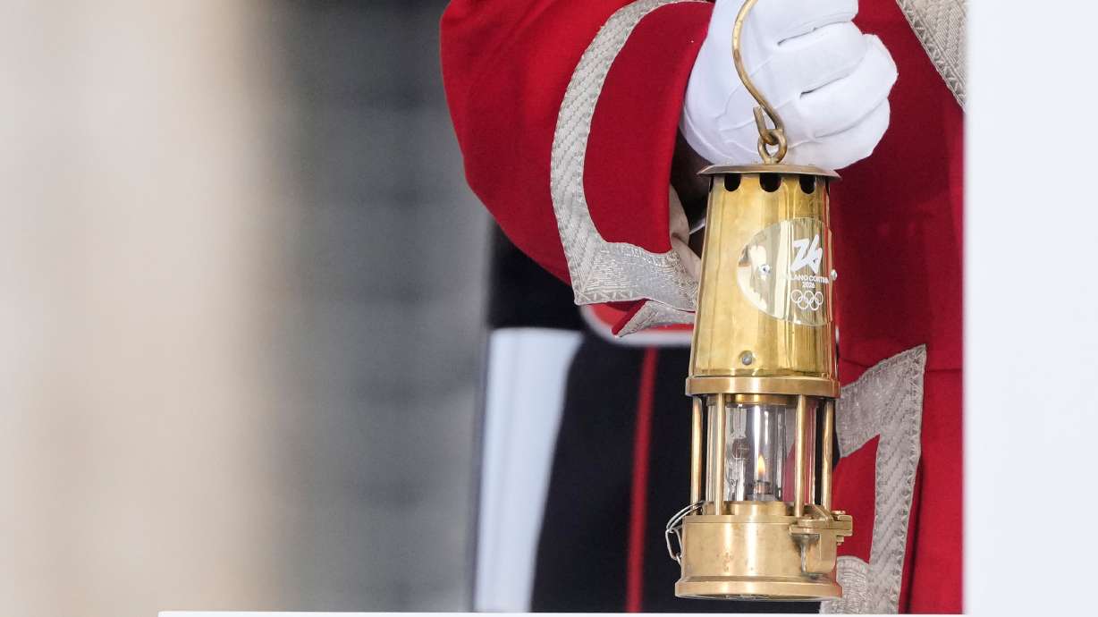 A cuirassier holds the torch lantern prior to the Milan Cortina 2026 Winter Olympics cauldron lighting, in front of the Quirinale Presidential Palace, in Rome, Friday Dec. 5, 2025.