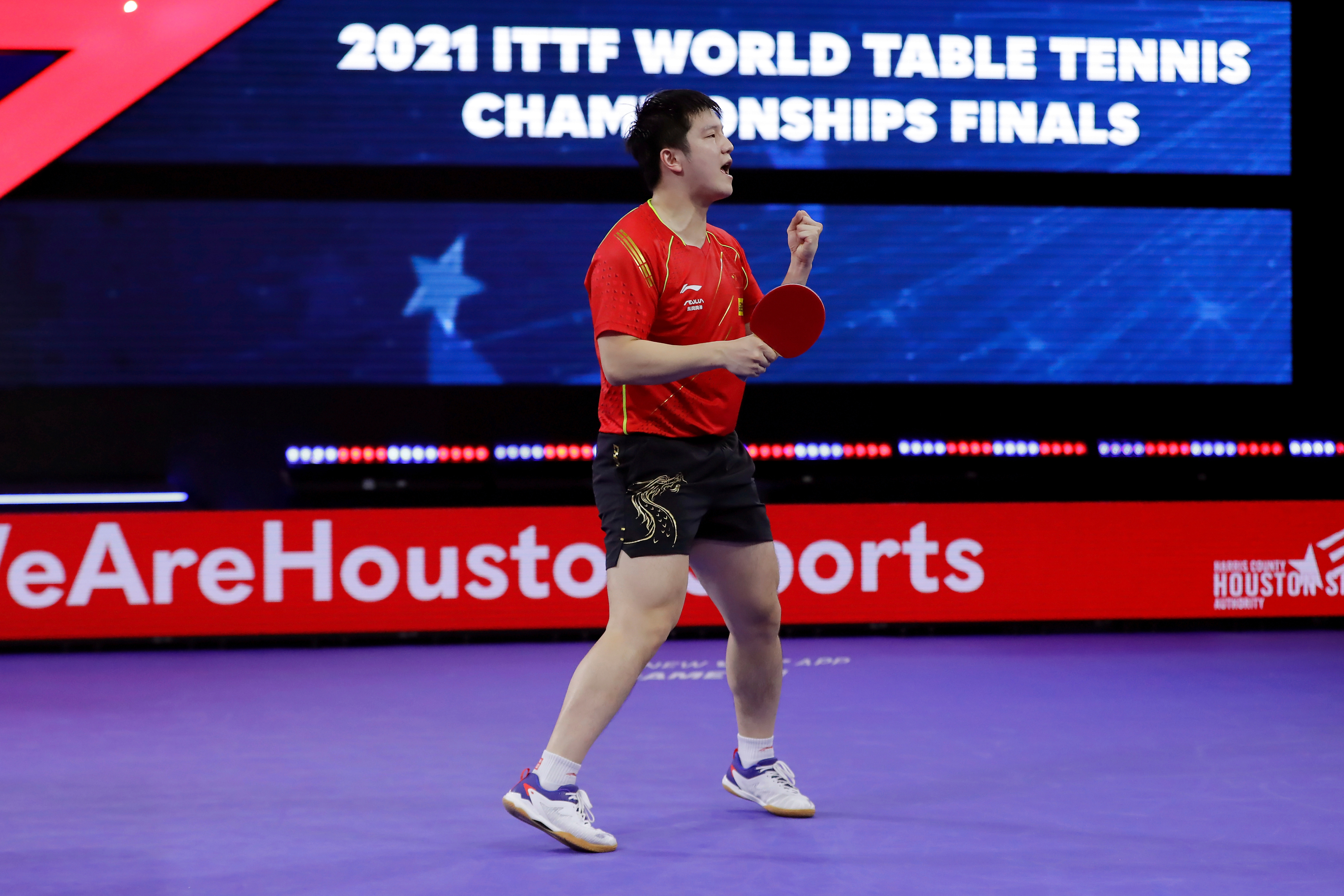 FILE - China's Zhendong Fan reacts after winning match point to take the men's singles finals match during the World Table Tennis Championships Monday, Nov. 29, 2021, in Houston.