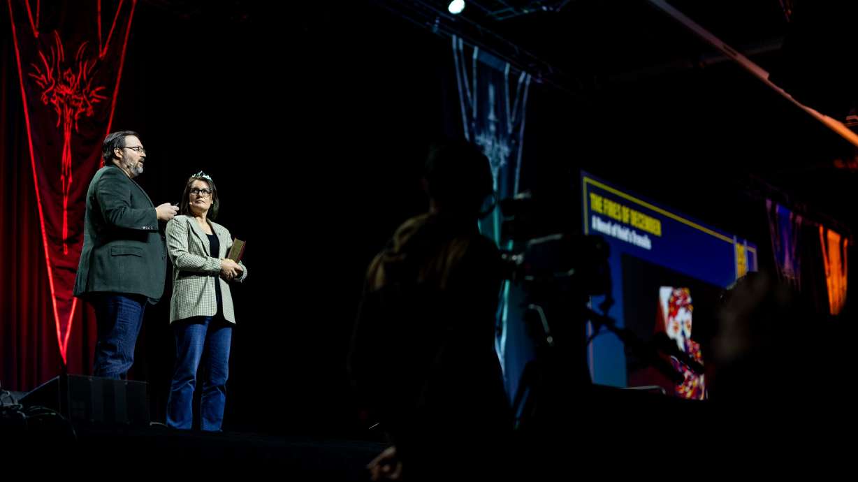 Brandon Sanderson and his wife, Emily Sanderson, speak during the release event for his upcoming book, "Tailored Realities," during Dragonsteel Nexus at the Salt Palace Convention Center in Salt Lake City on Thursday.