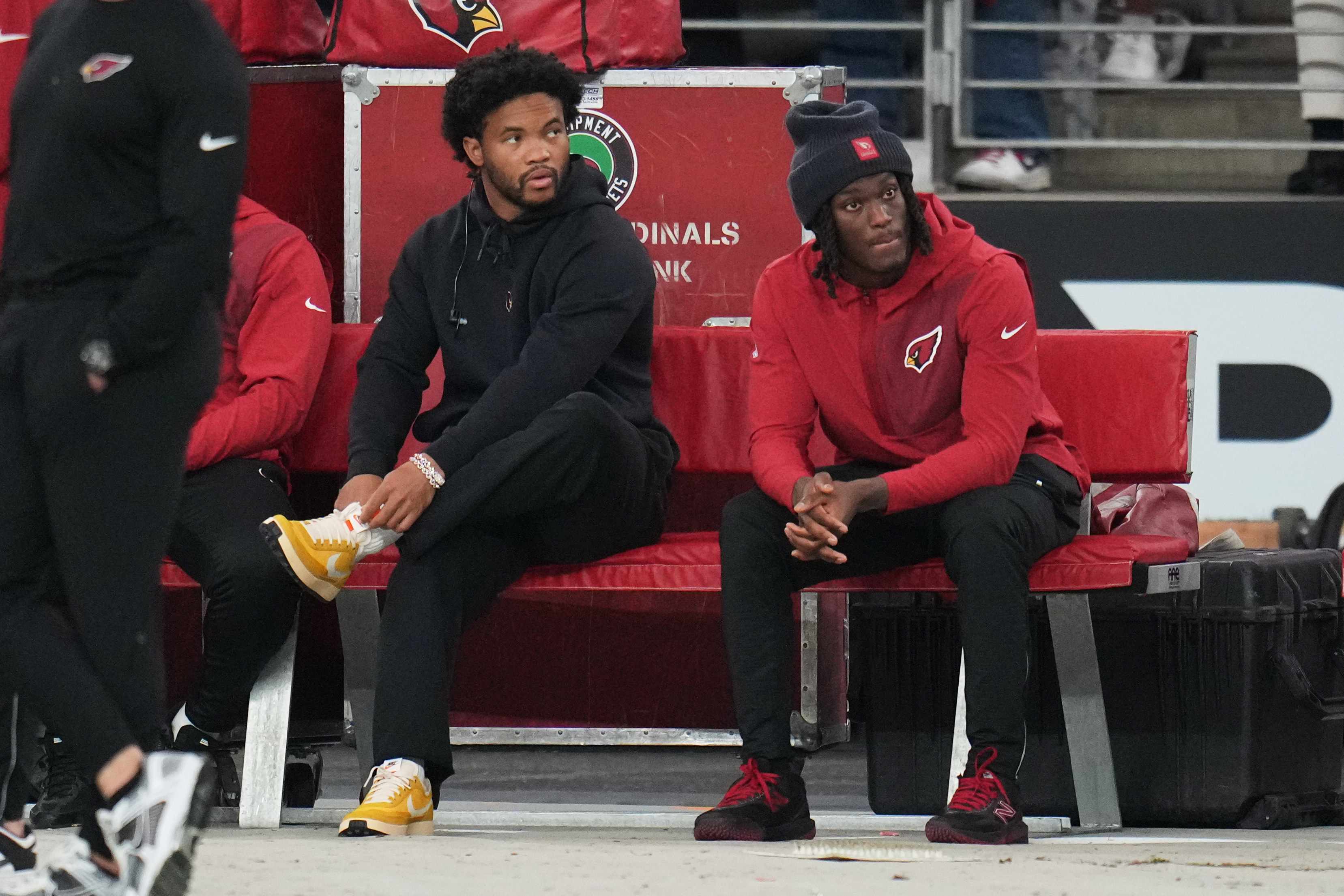 Arizona Cardinals quarterback Kyler Murray, left, and wide receiver Marvin Harrison Jr. sit on the bench during the first half of an NFL football game against the Jacksonville Jaguars Sunday, Nov. 23, 2025, in Glendale, Ariz.