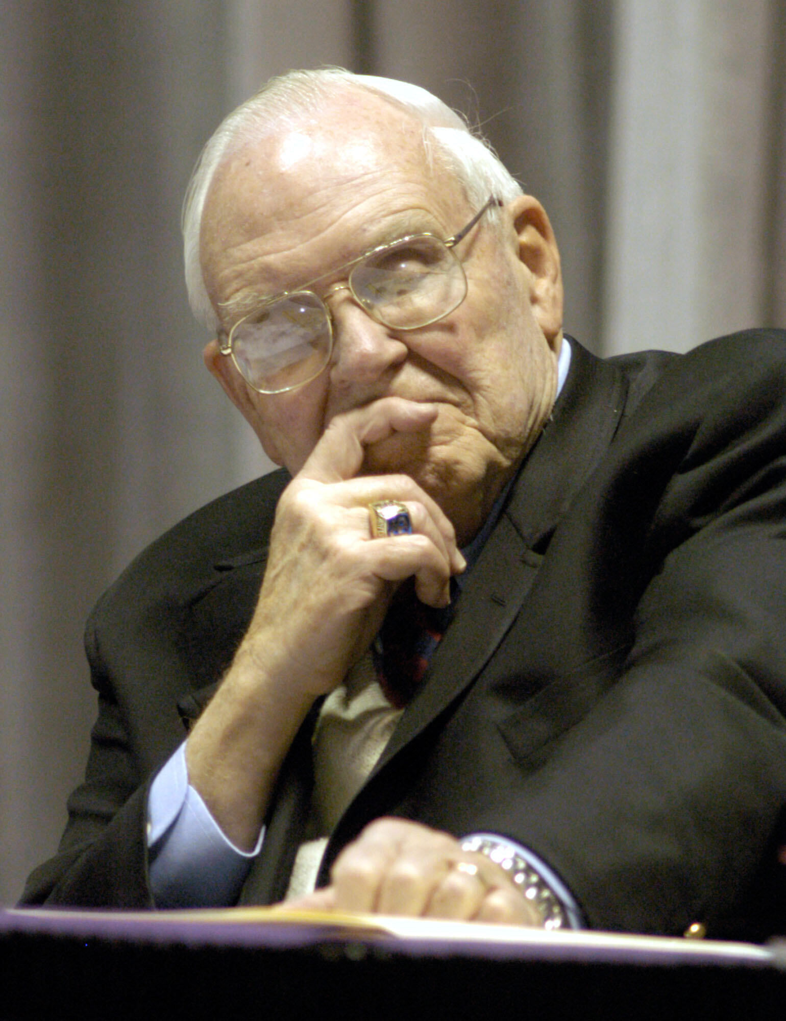 FILE - Roy Kramer, former commissioner , Southeastern Conference, listens to Mack Brown, Head Football Coach for The University of Texas, during his opening statement for the panel discussion for "Ethical Issues in College Athletics" in the Daniel-Meyer Coliseum on the Texas Christian University Campus, Thursday, Feb., 12, 2004.