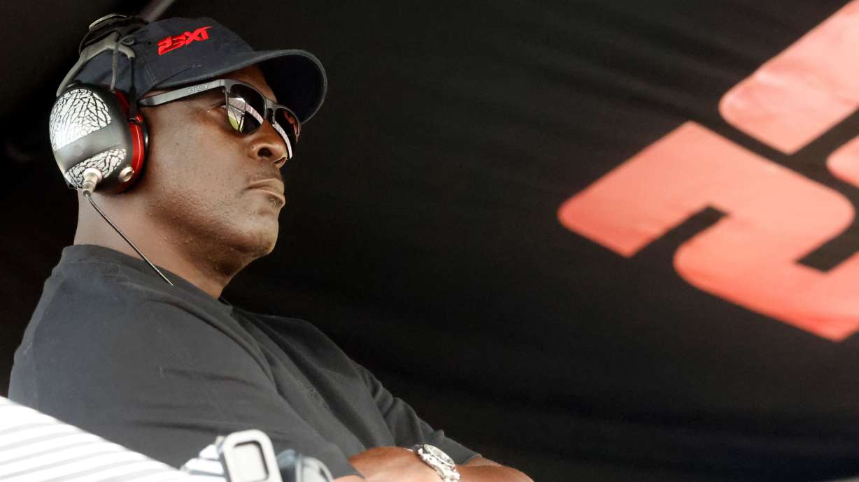 FILE - Michael Jordan, co-owner of 23XI Racing, sits in his pit box during a NASCAR Cup Series auto race at Talladega Superspeedway, Sunday, Oct. 6, 2024, in Talladega, Ala.