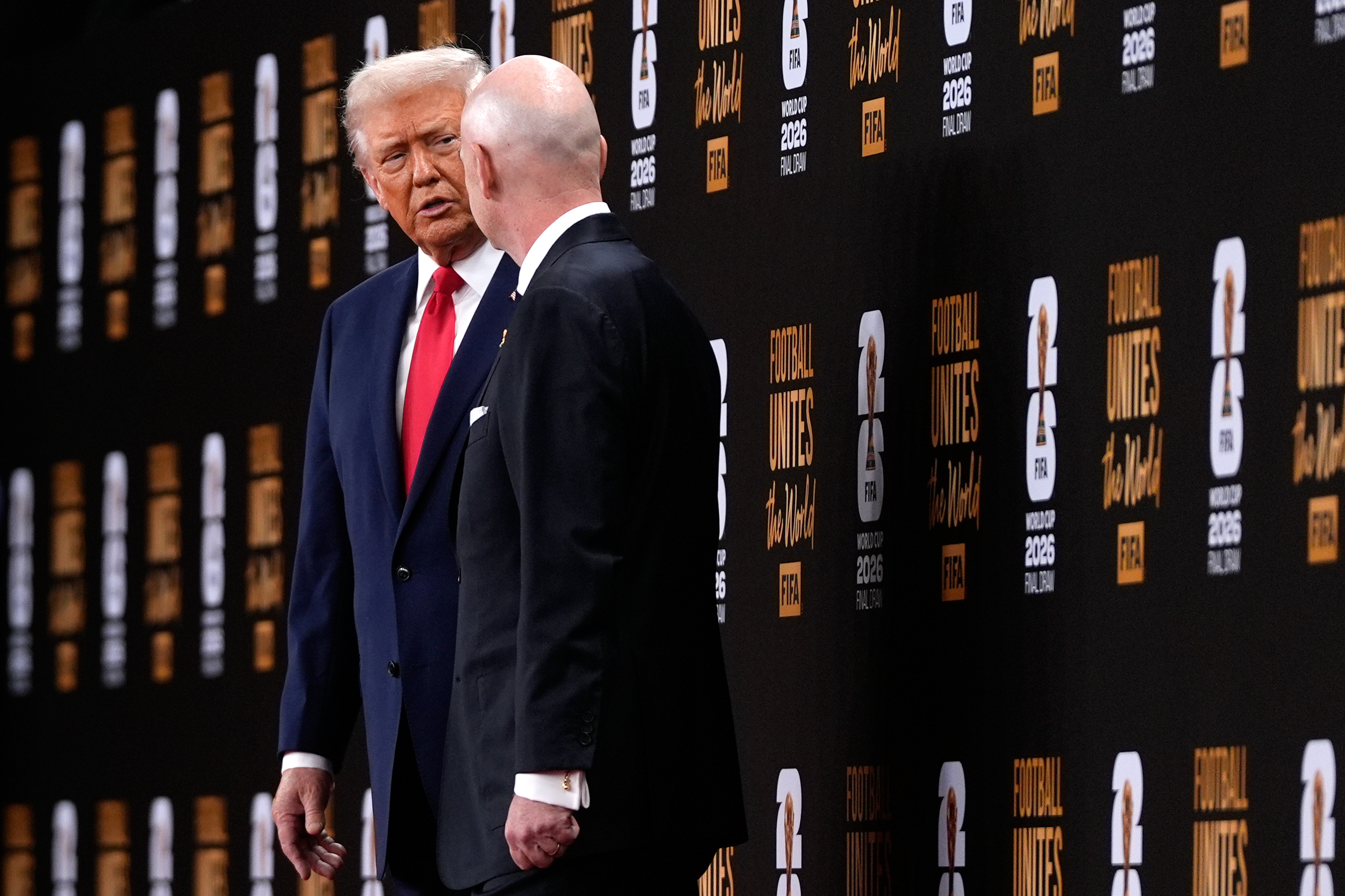 President Donald Trump speaks with FIFA President Gianni Infantino as they leave after the draw for the 2026 soccer World Cup at the Kennedy Center in Washington, Friday, Dec. 5, 2025. 