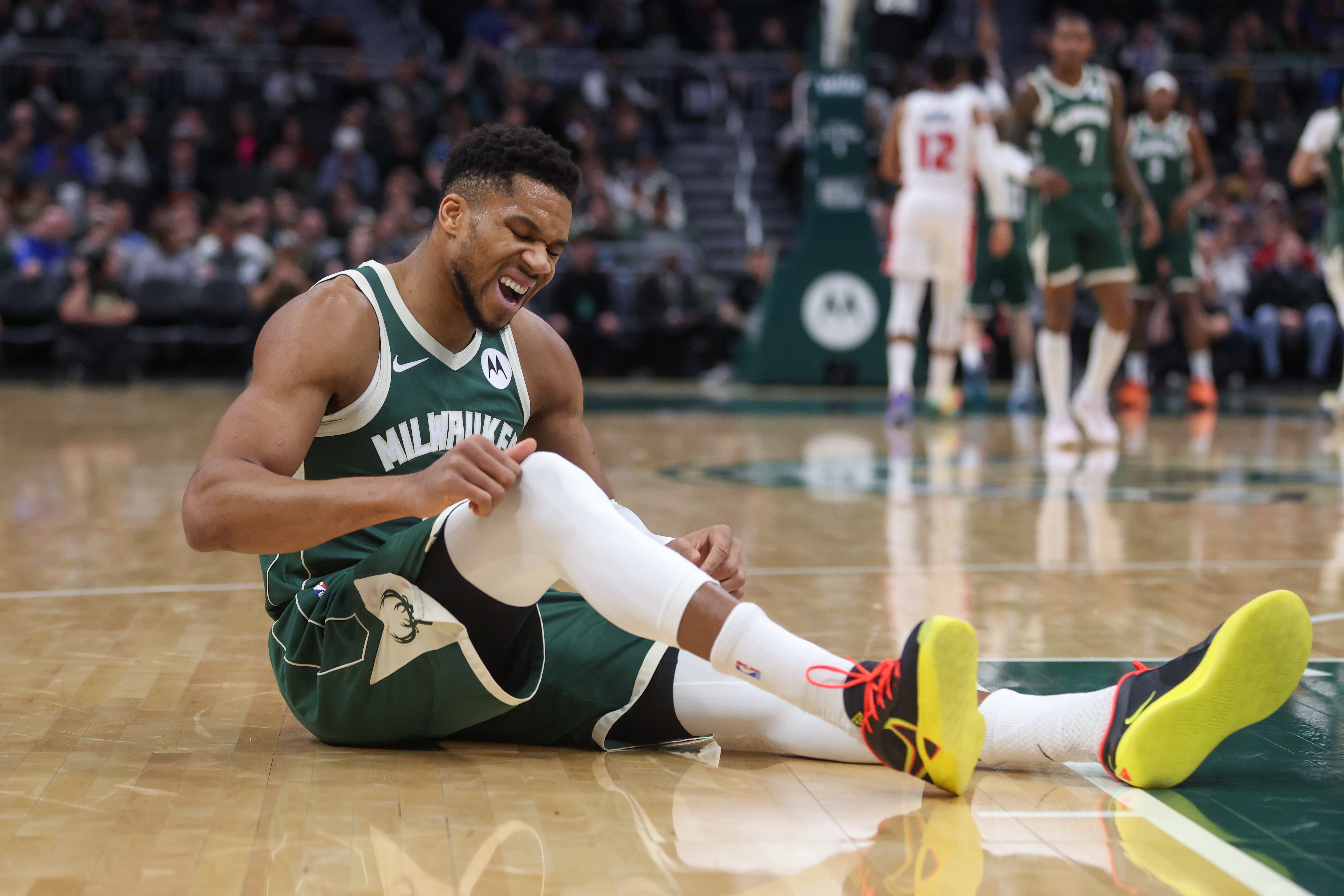 Milwaukee Bucks' Giannis Antetokounmpo reacts after suffering an injury during the first half an NBA basketball game against the Detroit Pistons, Wednesday, Dec. 3, 2025, in Milwaukee.