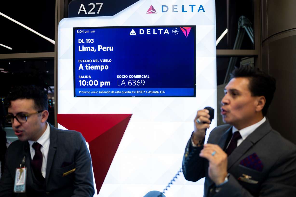 Victor Avalos, right, works as customer service agent for Delta’s maiden flight from Salt Lake City to Lima, Peru, operating daily seasonal service using a Boeing 767-300ER until Jan. 25, 2026, at the Salt Lake City International Airport in Salt Lake City on Thursday. The leadup to the flight felt like a party with speeches, dances, and balloons.