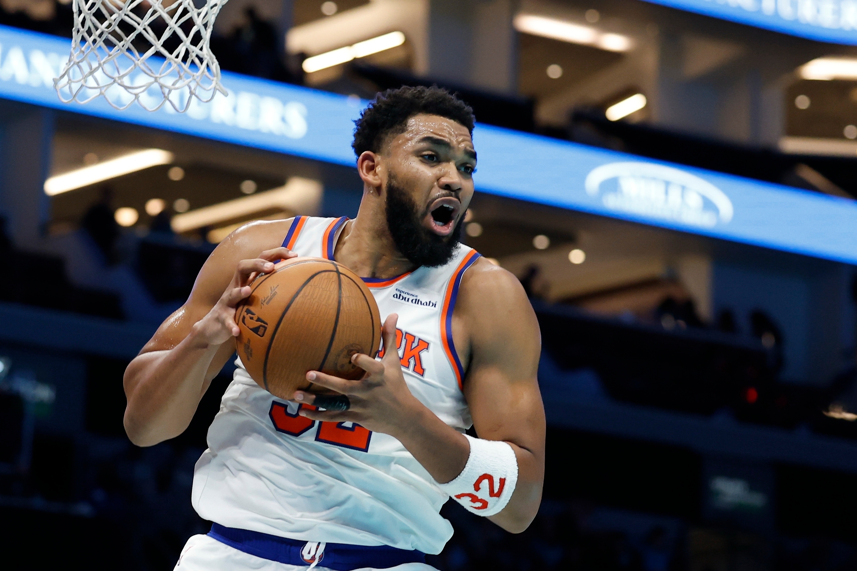 New York Knicks center Karl-Anthony Towns pulls down an offensive rebound during the second half of an Emirates NBA Cup basketball game against the Charlotte Hornets in Charlotte, N.C., Wednesday, Nov. 26, 2025.