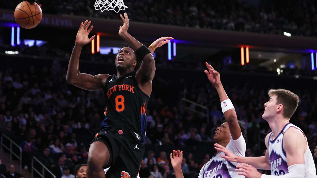 New York Knicks forward OG Anunoby (8) is fouled by Utah Jazz defenders during the second half of an NBA basketball game, Friday, Dec. 5, 2025, in New York.