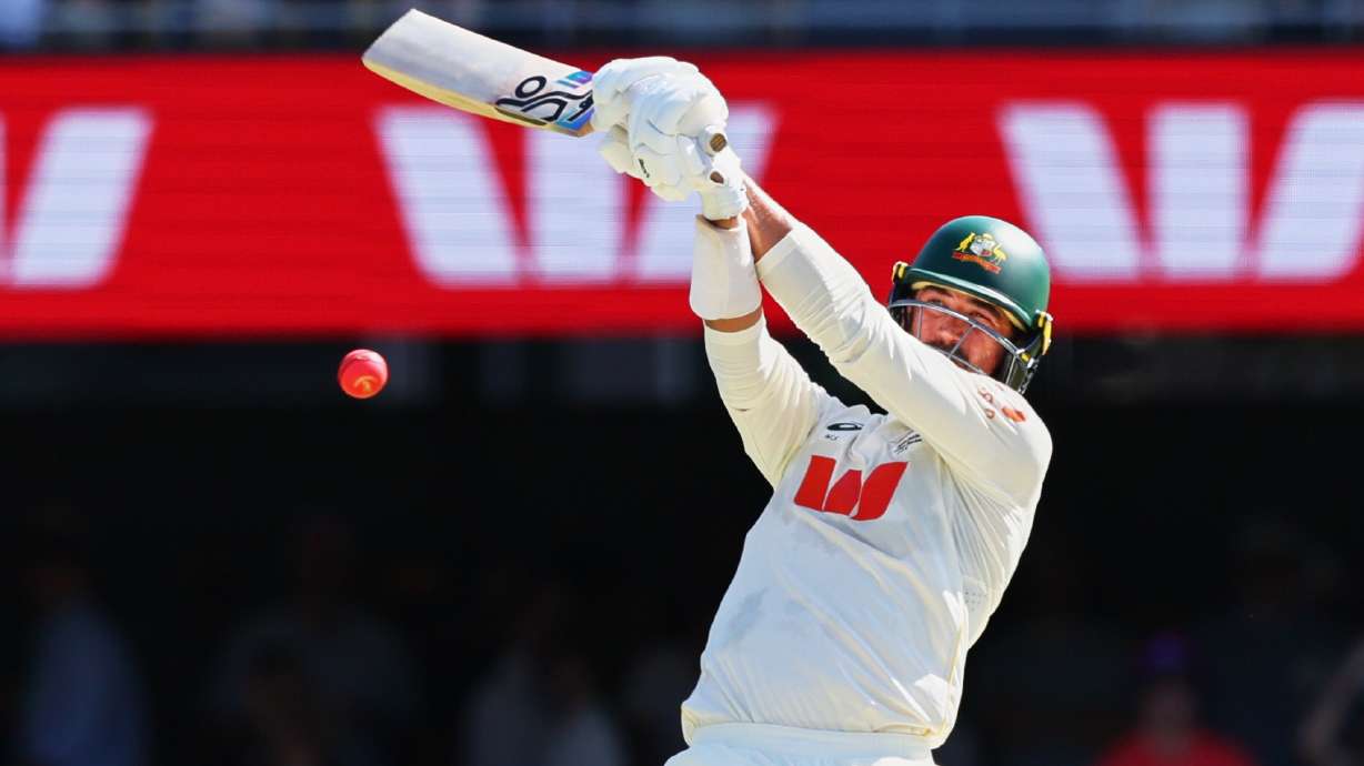 Australia's Mitchell Starc plays a shot during the second Ashes cricket test match between Australia and England in Brisbane, Saturday, Dec. 6, 2025..