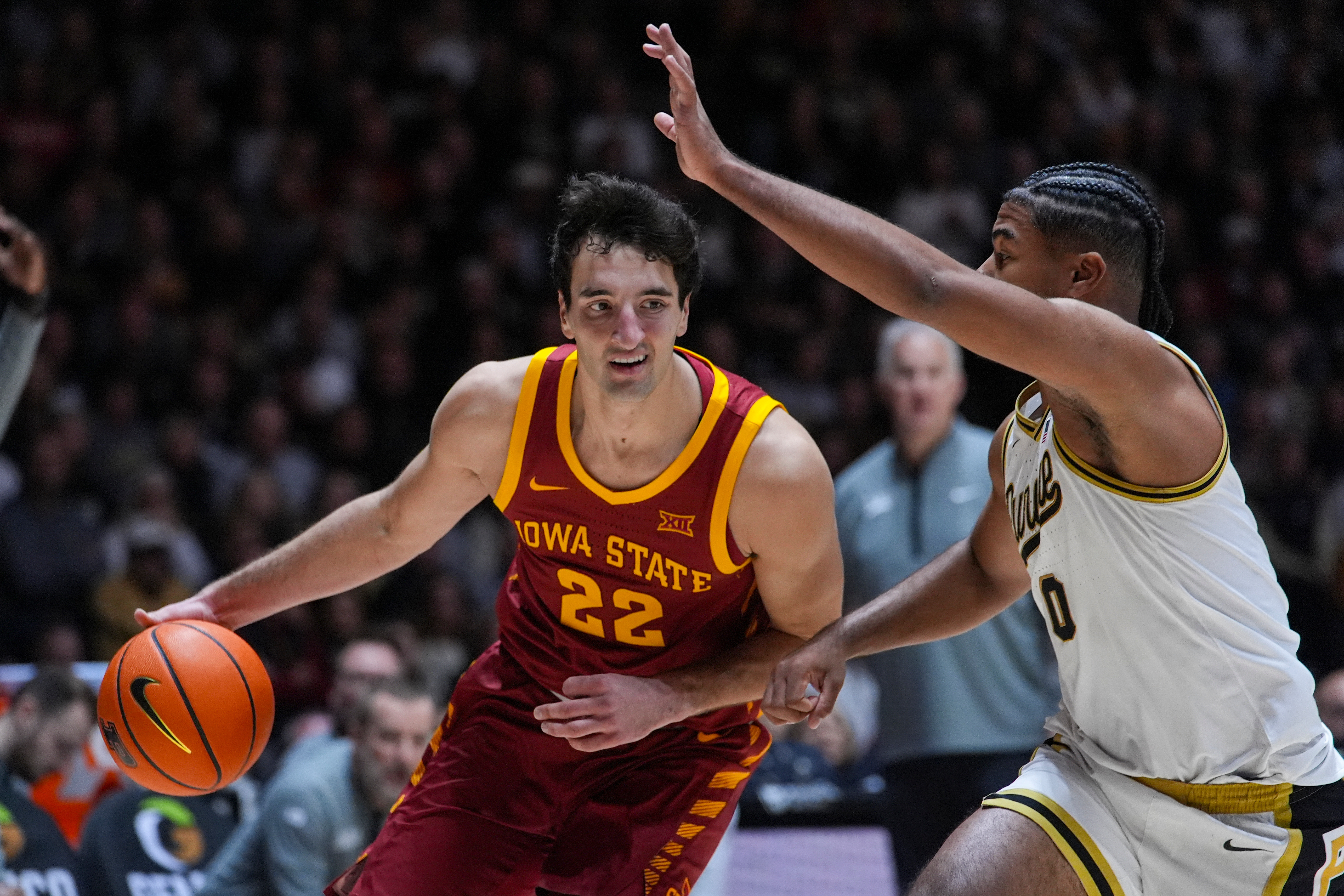Iowa State forward Milan Momcilovic (22) drives on Purdue guard C.J. Cox (0) during the first half of an NCAA college basketball game in West Lafayette, Ind., Saturday, Dec. 6, 2025. 