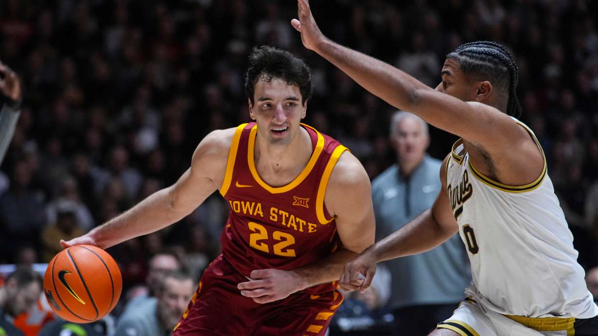 Iowa State forward Milan Momcilovic (22) drives on Purdue guard C.J. Cox (0) during the first half of an NCAA college basketball game in West Lafayette, Ind., Saturday, Dec. 6, 2025.