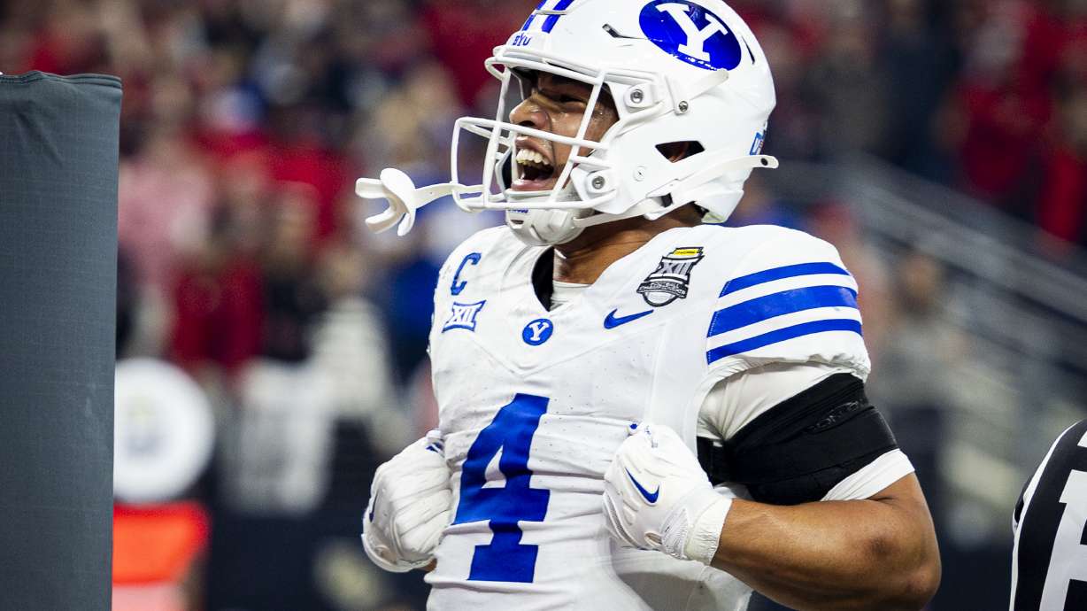 BYU running back LJ Martin (4) celebrates his touchdown during the Big 12 championship game against Texas Tech at AT&T Stadium in Arlington, Texas, on Saturday, Dec. 6, 2025.