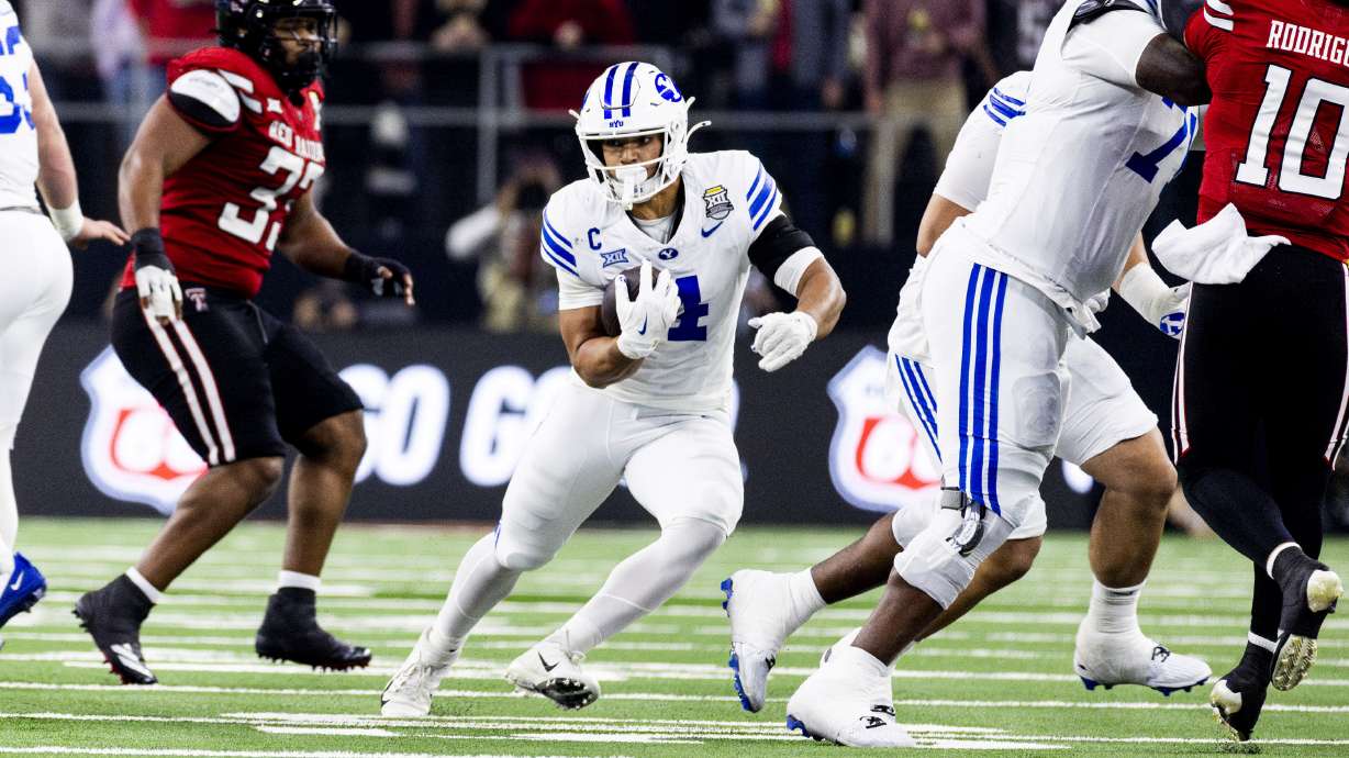 BYU running back LJ Martin (4) runs the ball against the Texas Tech defense during the Big 12 championship game at AT&T Stadium in Arlington, Texas, on Saturday, Dec. 6, 2025.