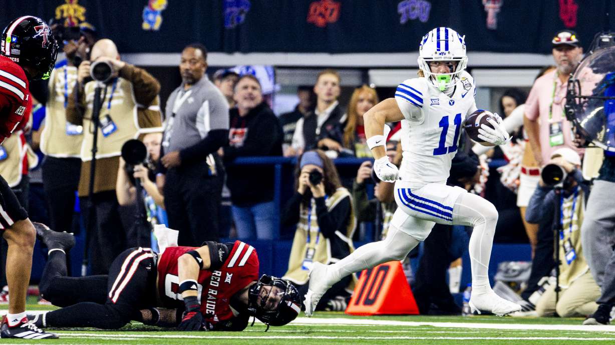 BYU wide receiver Parker Kingston (11) slips away from Texas Tech linebacker John Curry (6) as he runs the ball during the Big 12 championship game at AT&T Stadium in Arlington, Texas, on Saturday, Dec. 6, 2025.