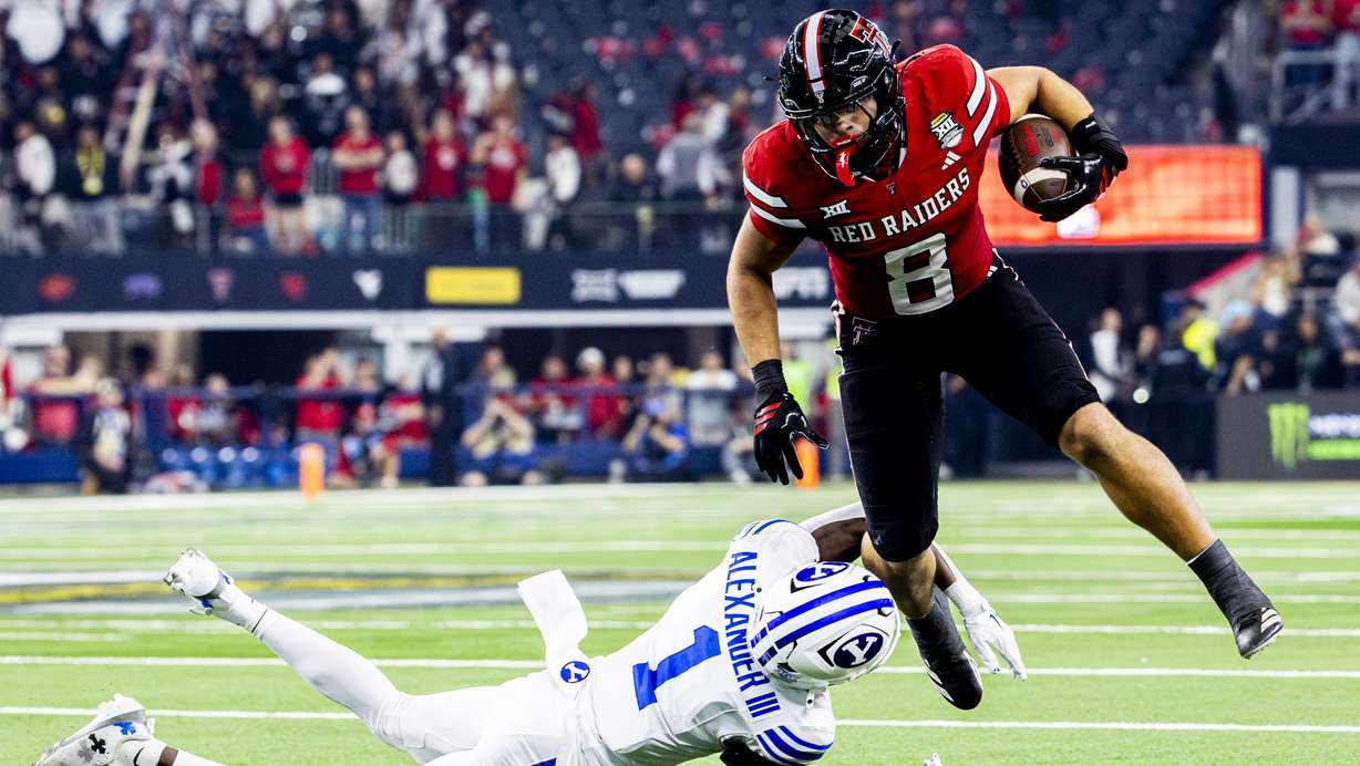 BYU cornerback Therrian Alexander III (1) tries to down Texas Tech running back Cameron Dickey (8) during the Big 12 championship game at AT&T Stadium in Arlington, Texas, on Saturday, Dec. 6, 2025.
