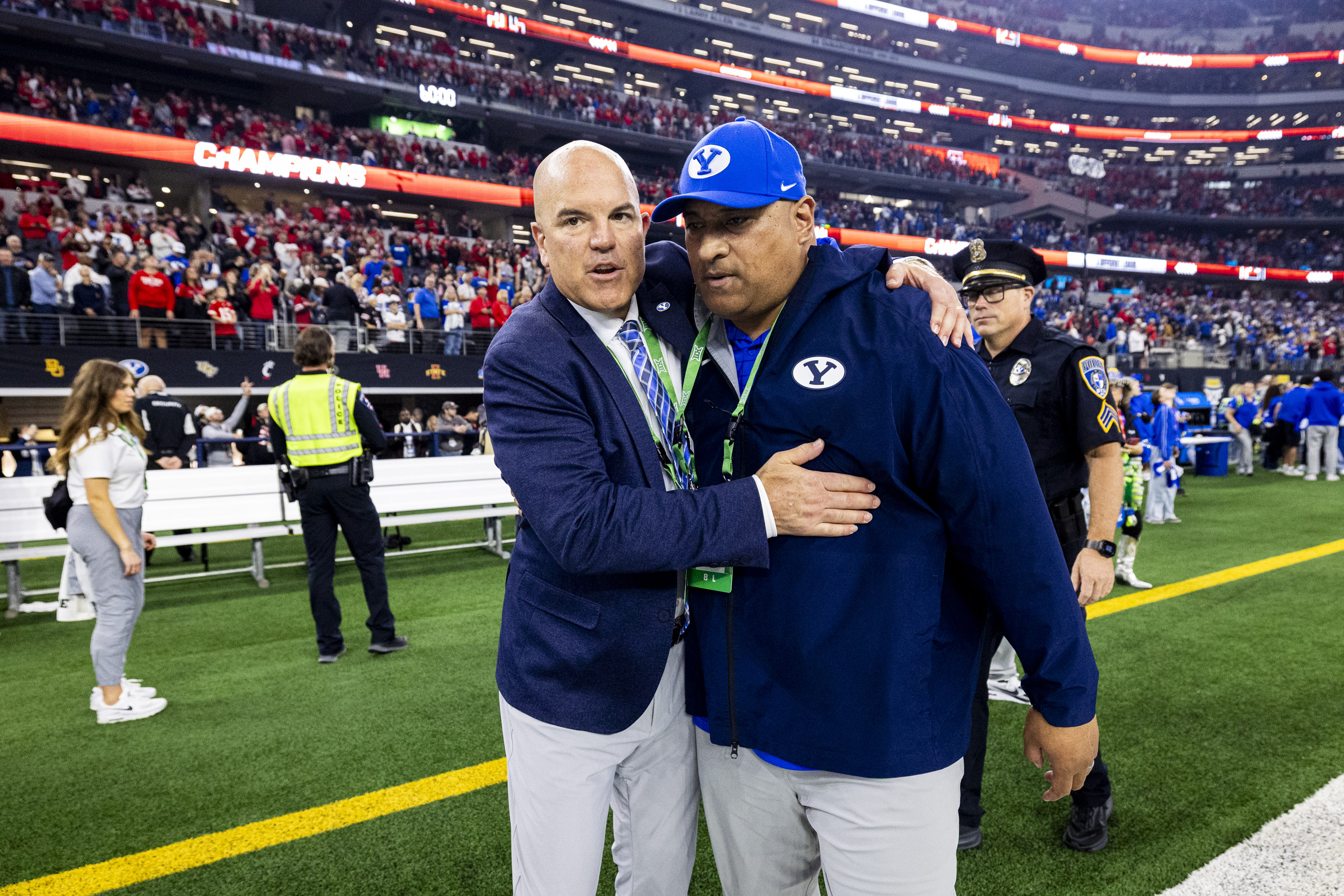 BYU director of athletics Brian Santiago, left, hugs head coach Kalani Sitake after Texas Tech defeated BYU in the Big 12 championship game at AT&T Stadium in Arlington, Texas, on Saturday, Dec. 6, 2025.