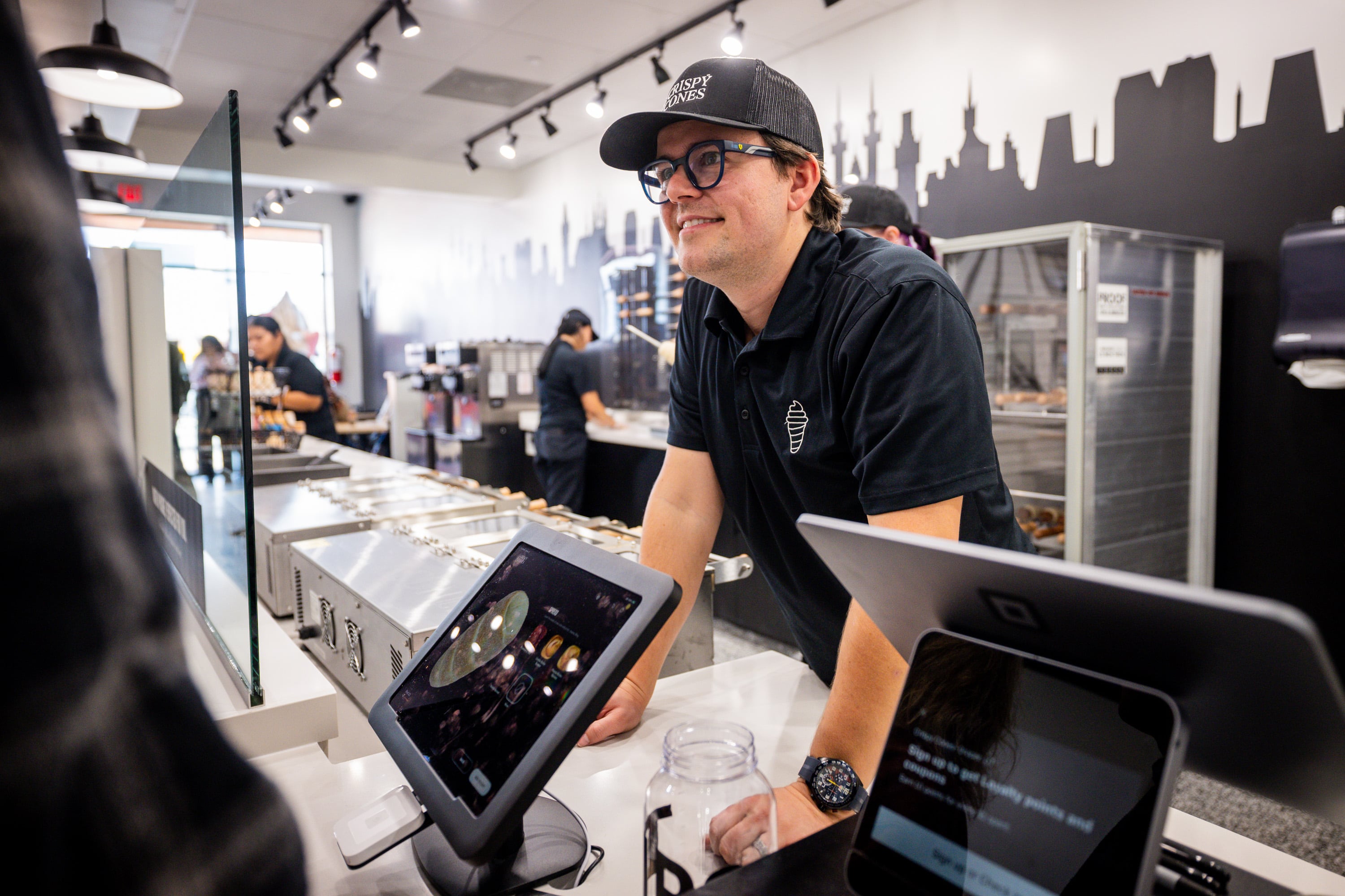 Crispy Cones franchise owner Andrei Popa speaks to customers at the opening of a new Crispy Cones location in Draper on Nov. 21. Popa, who is from Romania, is familiar with the type of cones the company creates.