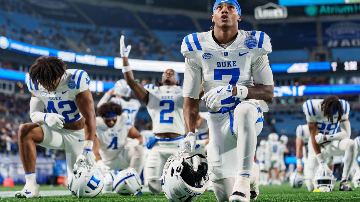 Duke wide receiver Que'Sean Brown (7) takes a knee before the Atlantic Coast Conference championship NCAA college football game against Virginia, Saturday, Dec. 6, 2025, in Charlotte, N.C.