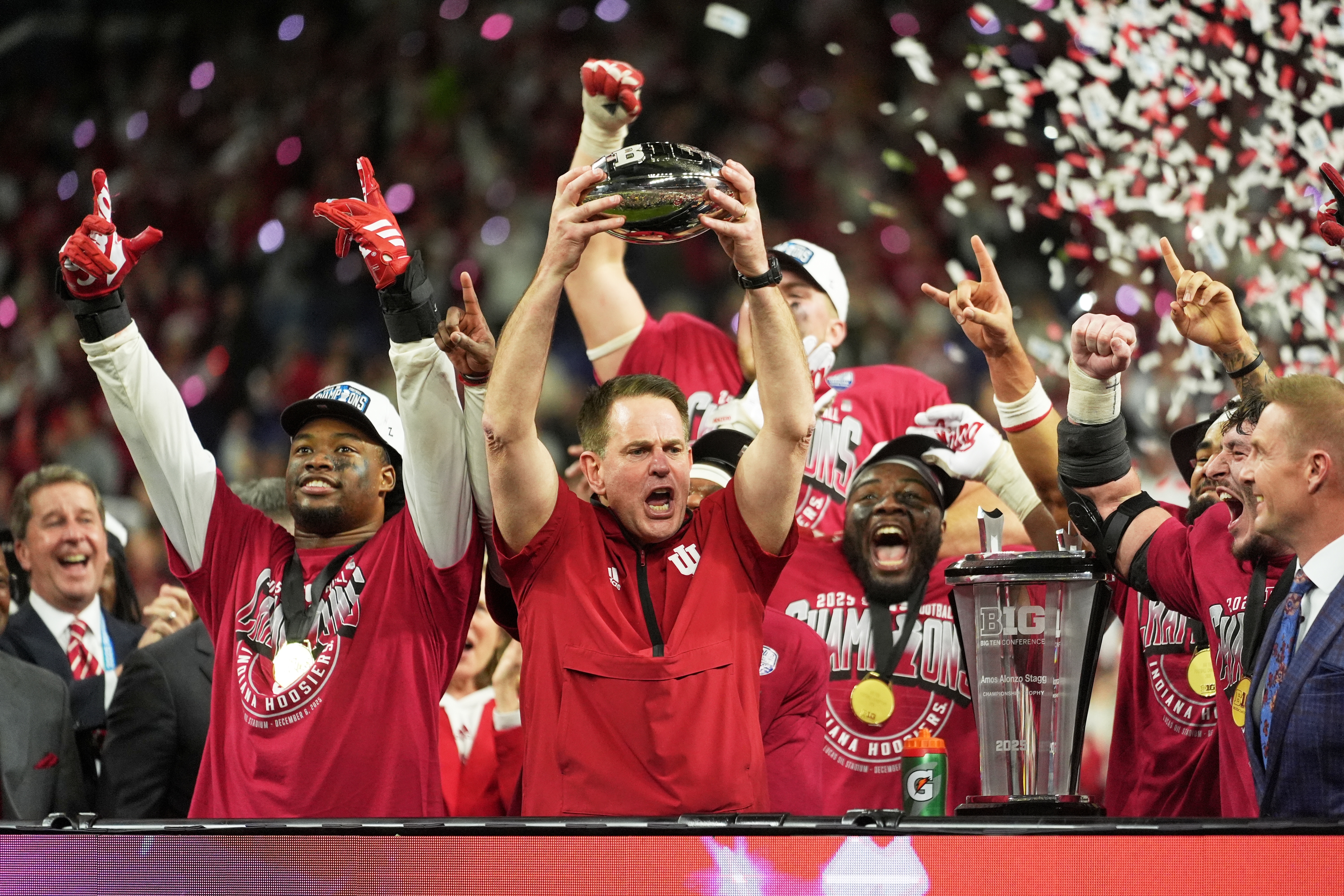Indiana head coach Curt Cignetti holds up the championship trophy after the Big Ten championship NCAA college football game against Ohio State in Indianapolis, Saturday, Dec. 6, 2025.
