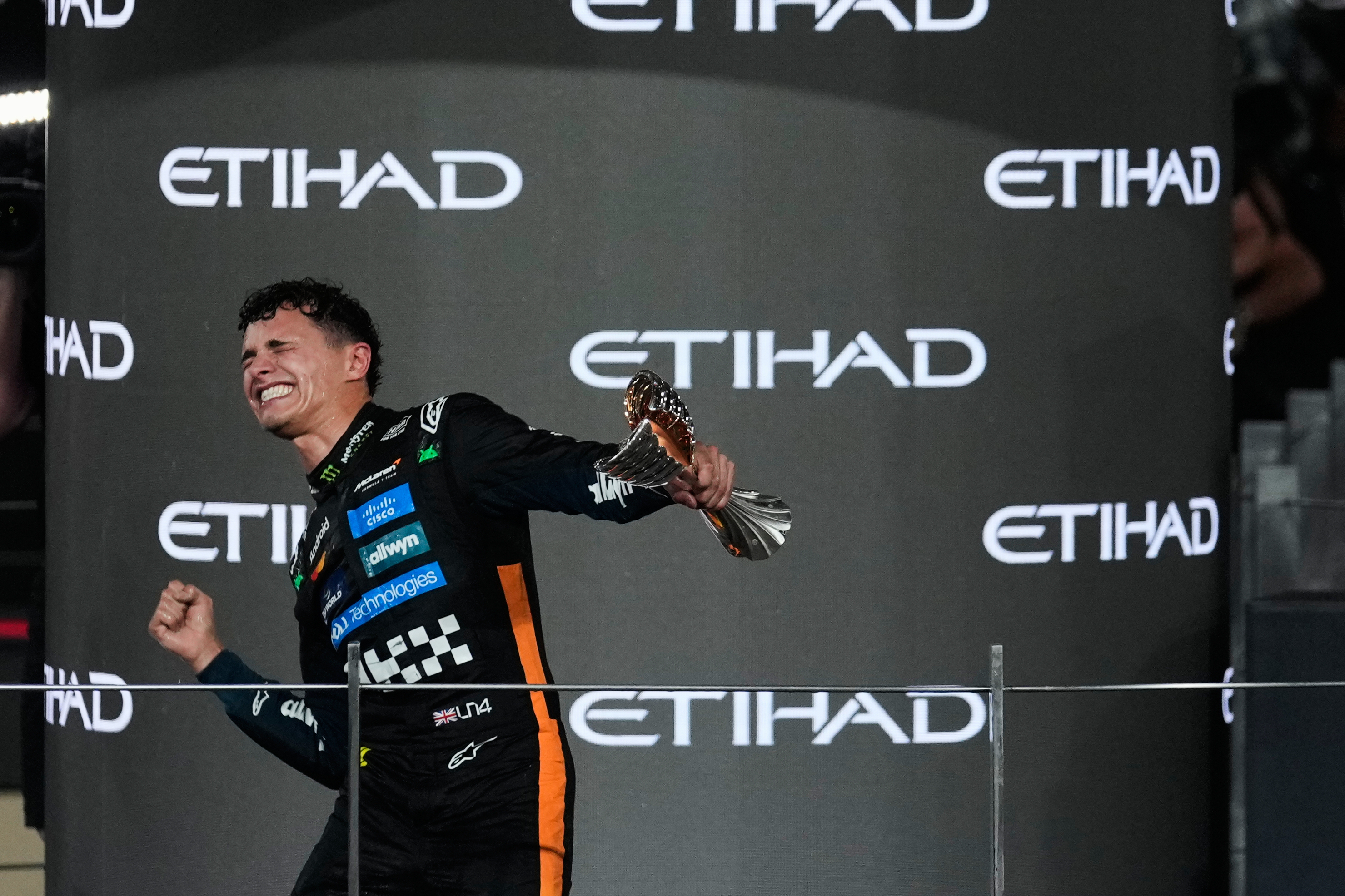 McLaren driver Lando Norris of Britain celebrates after becoming a world champion after the Formula One Abu Dhabi Grand Prix at the Yas Marina Circuit in Abu Dhabi, UAE, Sunday, Dec. 7, 2025.
