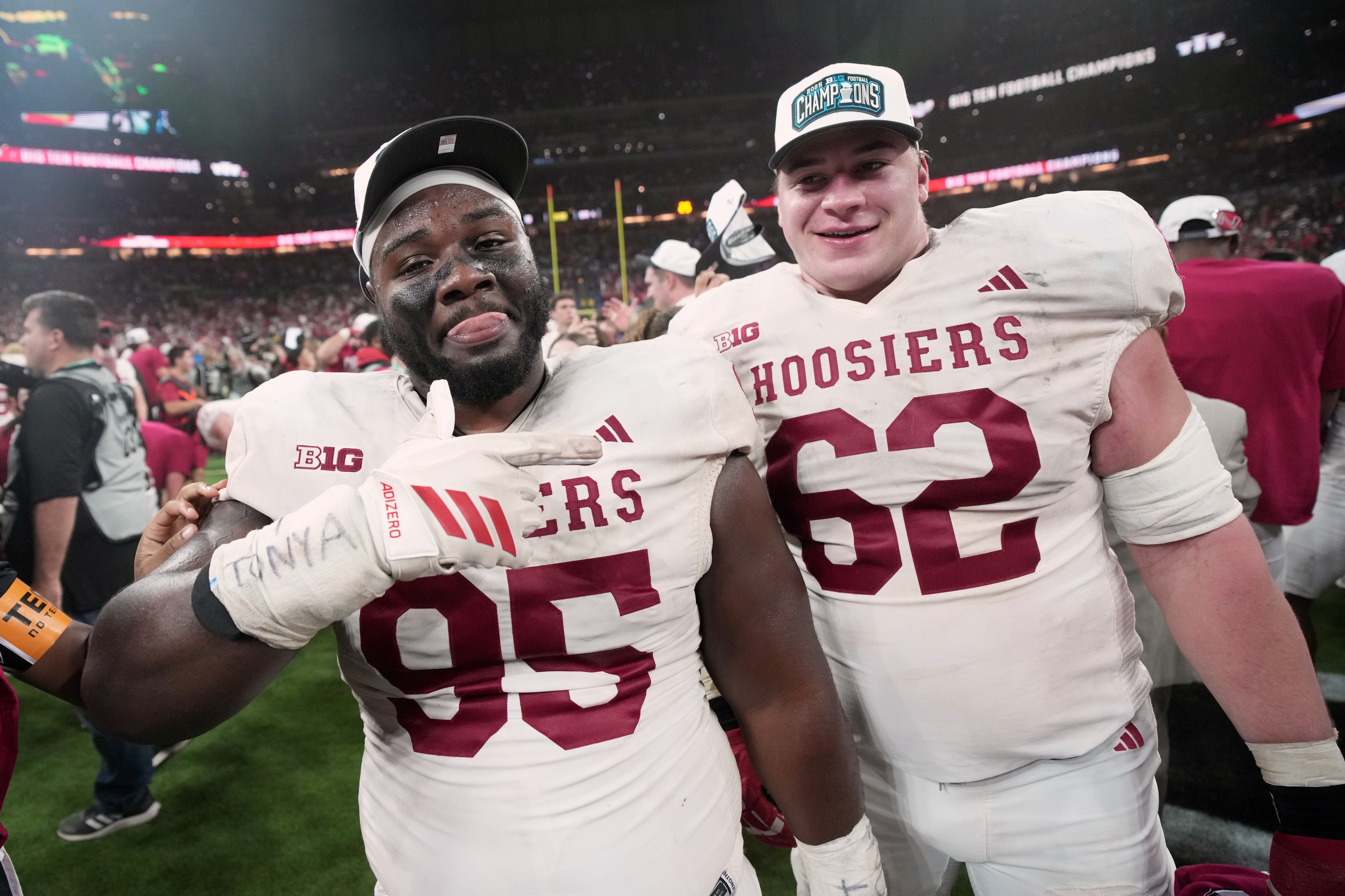 Indiana's Tyrique Tucker and Drew Evans celebrate after the Big Ten championship NCAA college football game against Ohio State in Indianapolis, Saturday, Dec. 6, 2025.