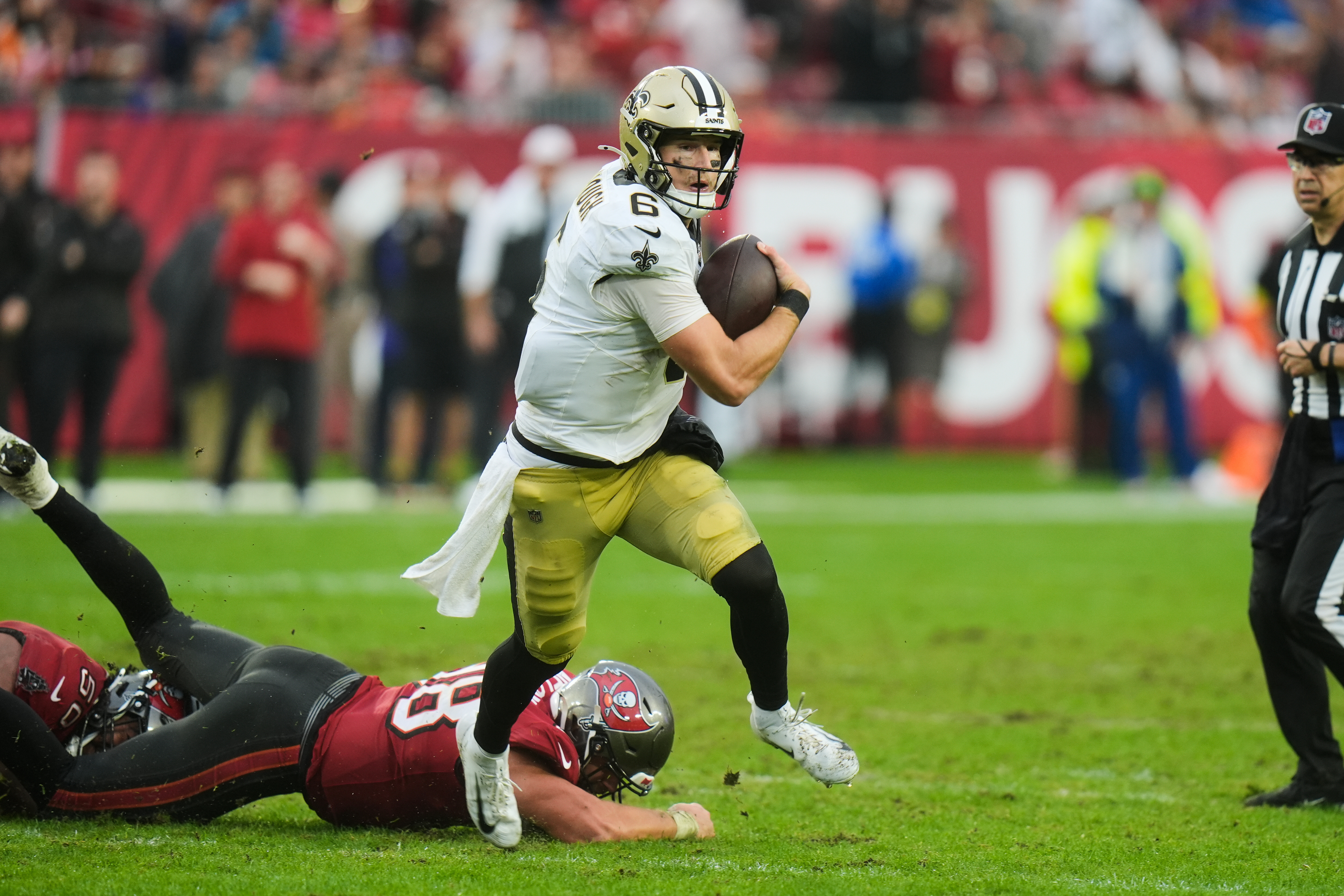 New Orleans Saints quarterback Tyler Shough (6) carries for a touchdown past Tampa Bay Buccaneers safety Rashad Wisdom (38) in the second half of an NFL football game, Sunday, Dec. 7, 2025, in Tampa, Fla.