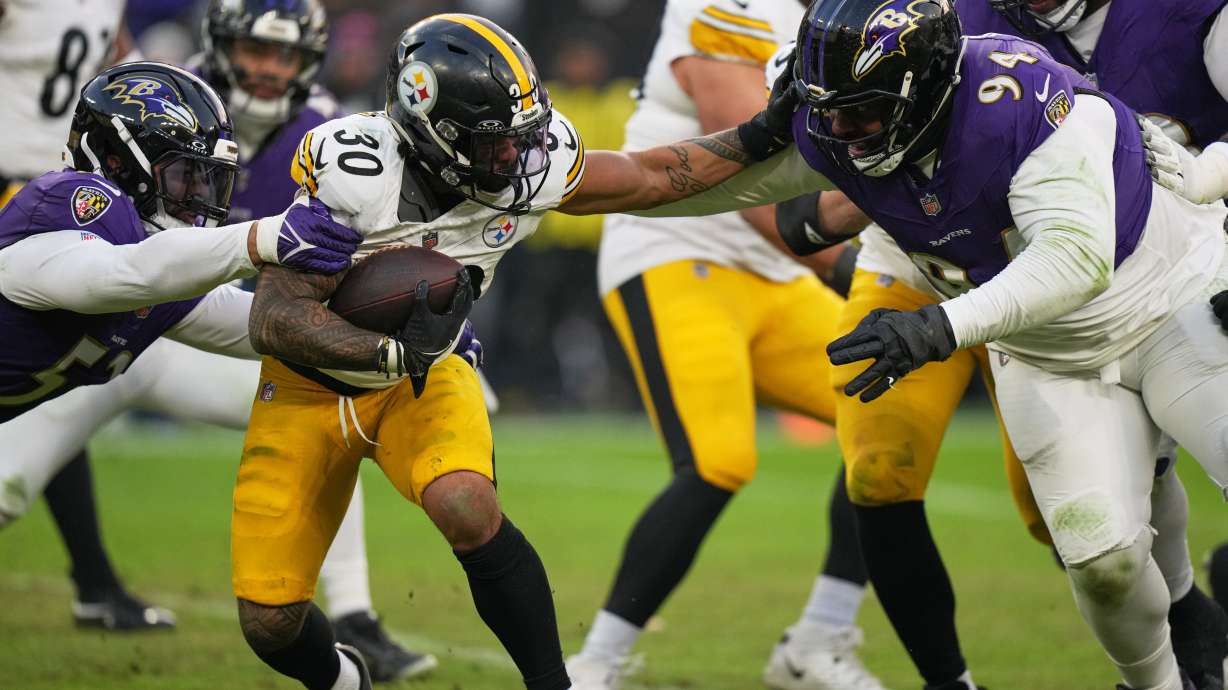Baltimore Ravens linebacker Kyle van Noy, left, and defensive tackle John Jenkins (94) tackle Pittsburgh Steelers running back Jaylen Warren (30) during the second half of an NFL football game, Sunday, Dec. 7, 2025, in Baltimore.