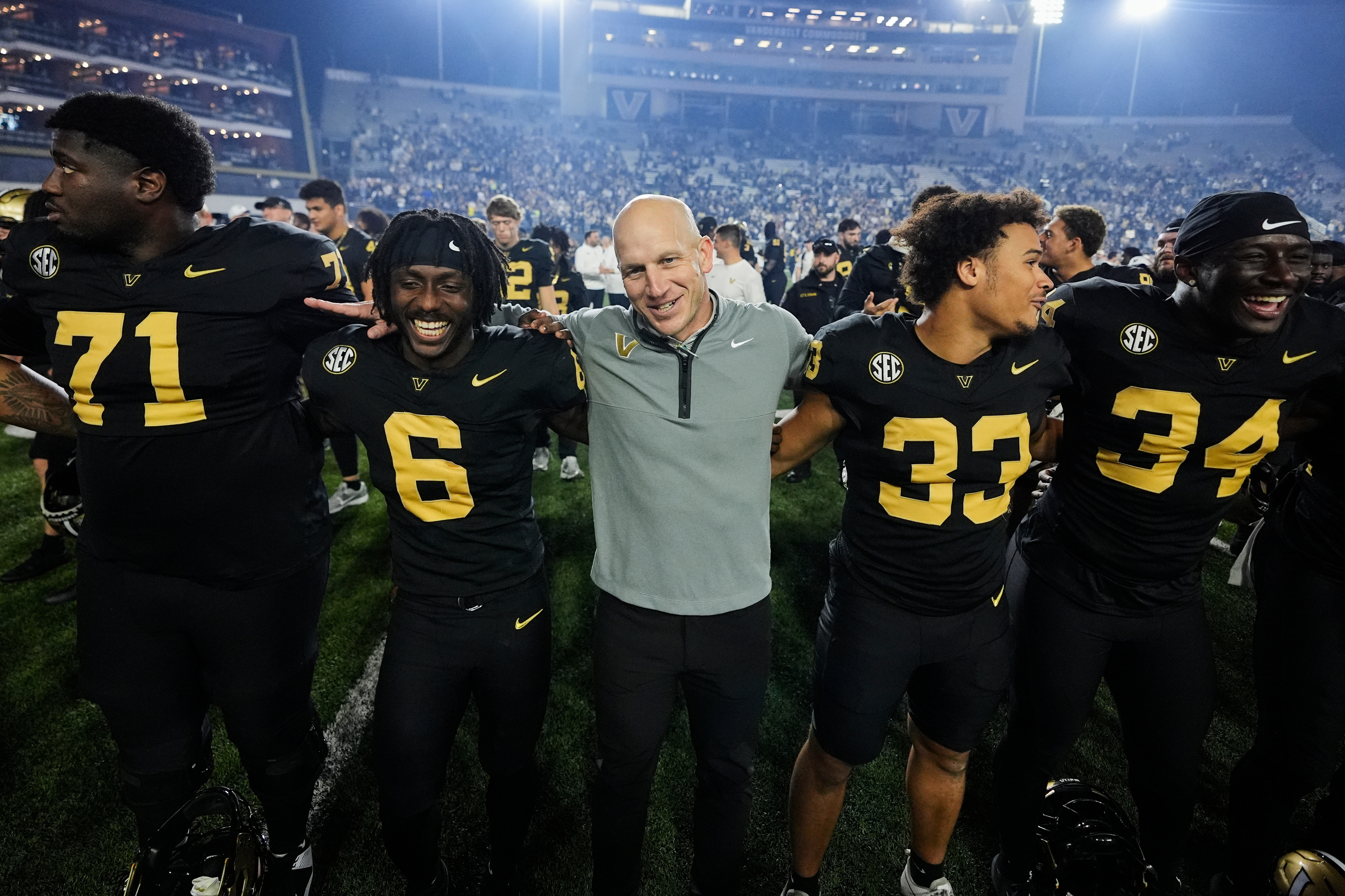 Vanderbilt head coach Clark Lea, center, celebrates the team's win with players after an NCAA college football game against Kentucky, Saturday, Nov. 22, 2025, in Nashville, Tenn.