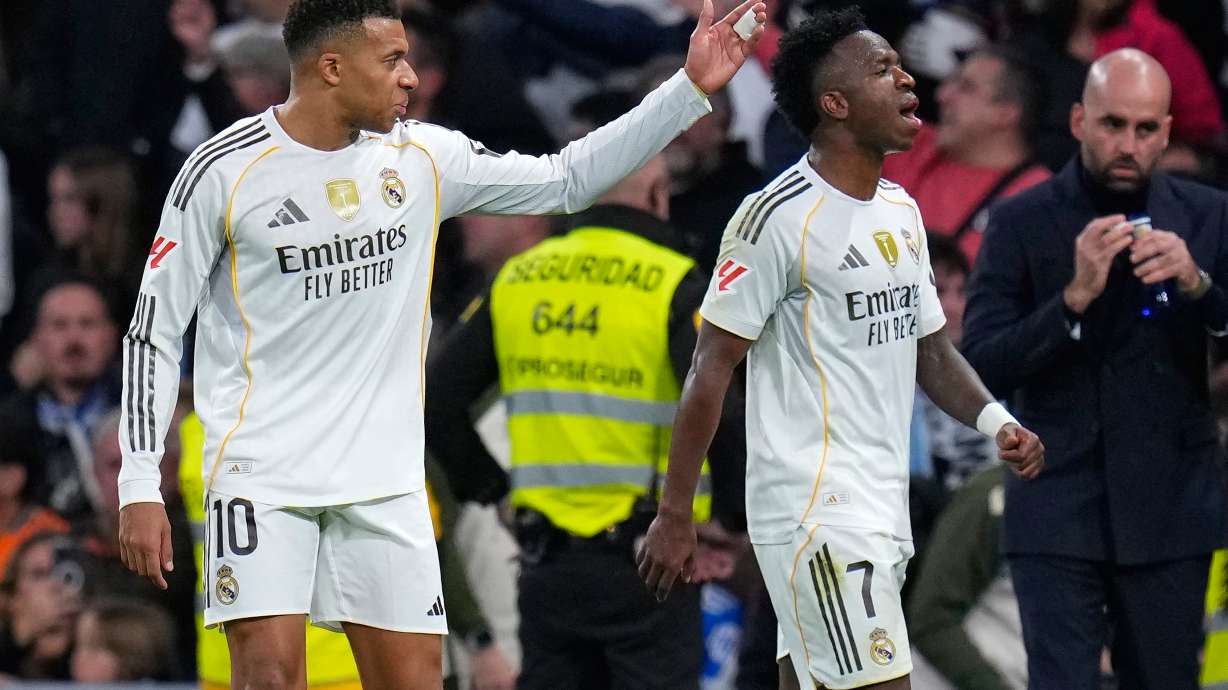 Real Madrid's Kylian Mbappe, left, and Vinicius Junior react during the Spanish La Liga soccer match between Real Madrid and Celta Vigo in Madrid, Spain, Sunday, Dec. 7, 2025.