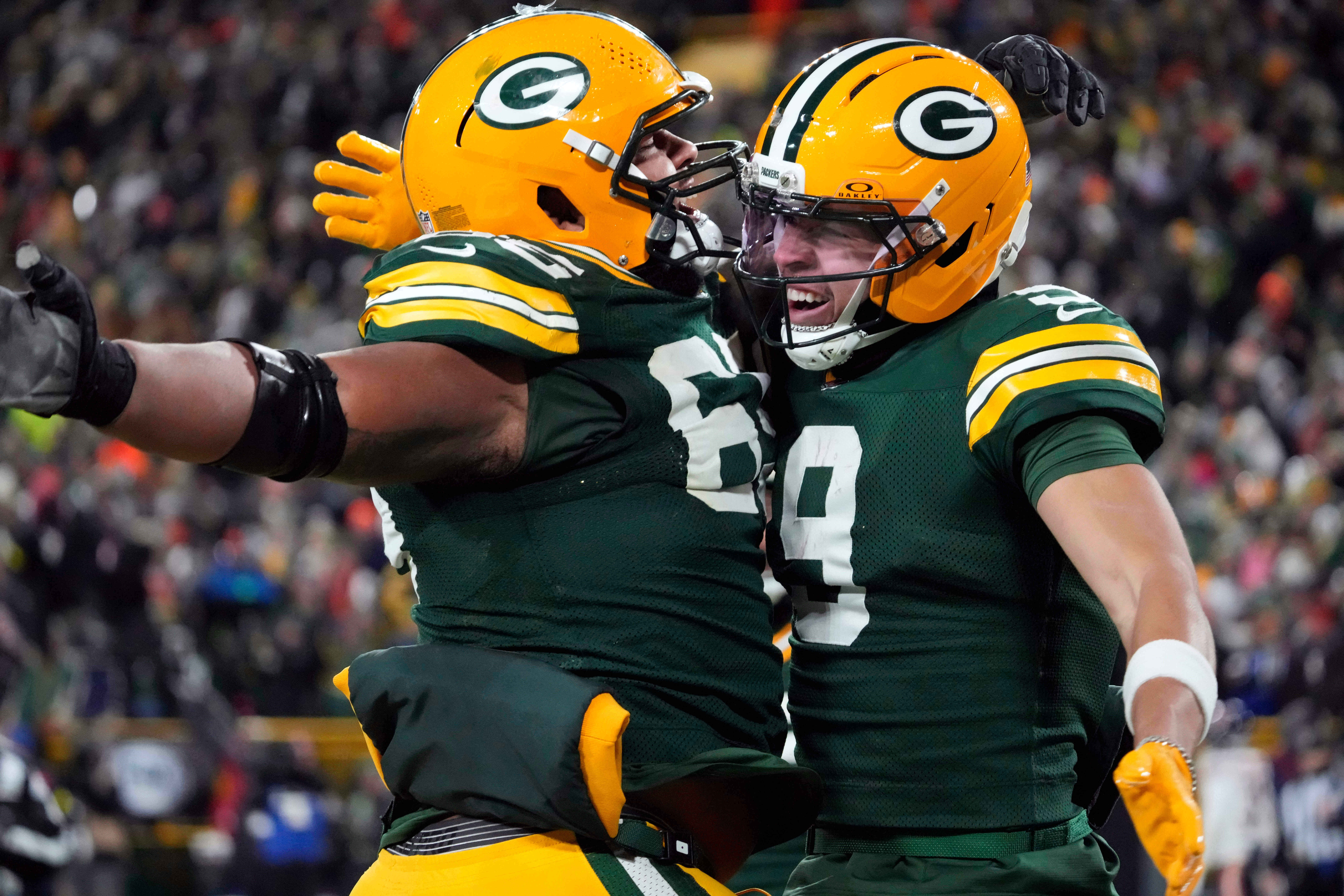 Green Bay Packers wide receiver Christian Watson (9) celebrates with guard Aaron Banks (65) after scoring a touchdown against the Chicago Bears during the second half of an NFL football game Sunday, Dec. 7, 2025, in Green Bay, Wis.