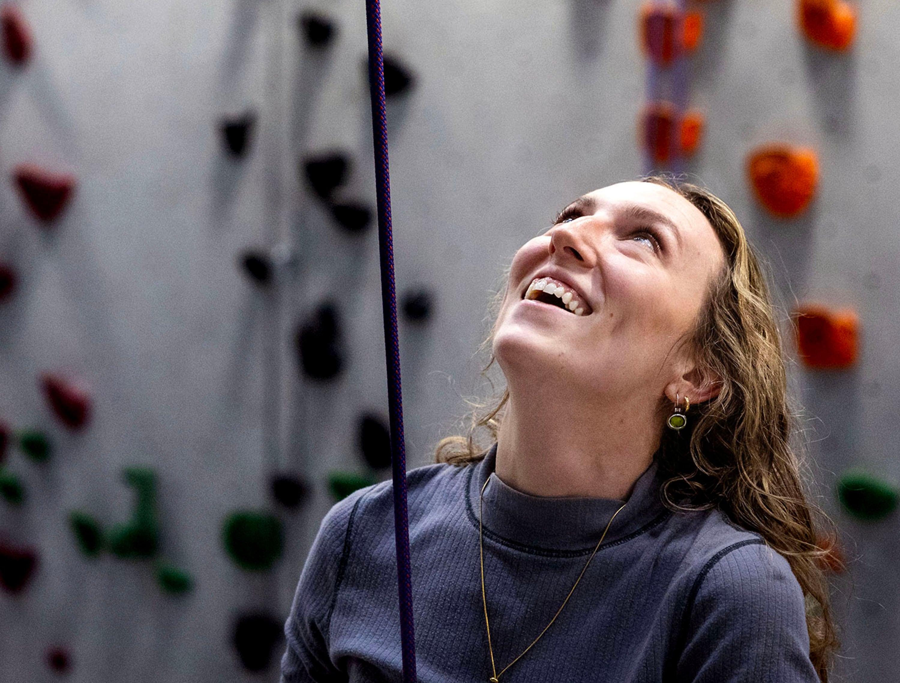 Catholic Community Services volunteer Quinn Hennessy smiles as one of the Zakariy children climbs at Momentum Climbing Gym in Millcreek on Nov. 12.  Hennessy has been a volunteer with the CCS refugee mentor program for two years. The Zakariy family, from Sudan, is the second family she has worked with since joining the program.